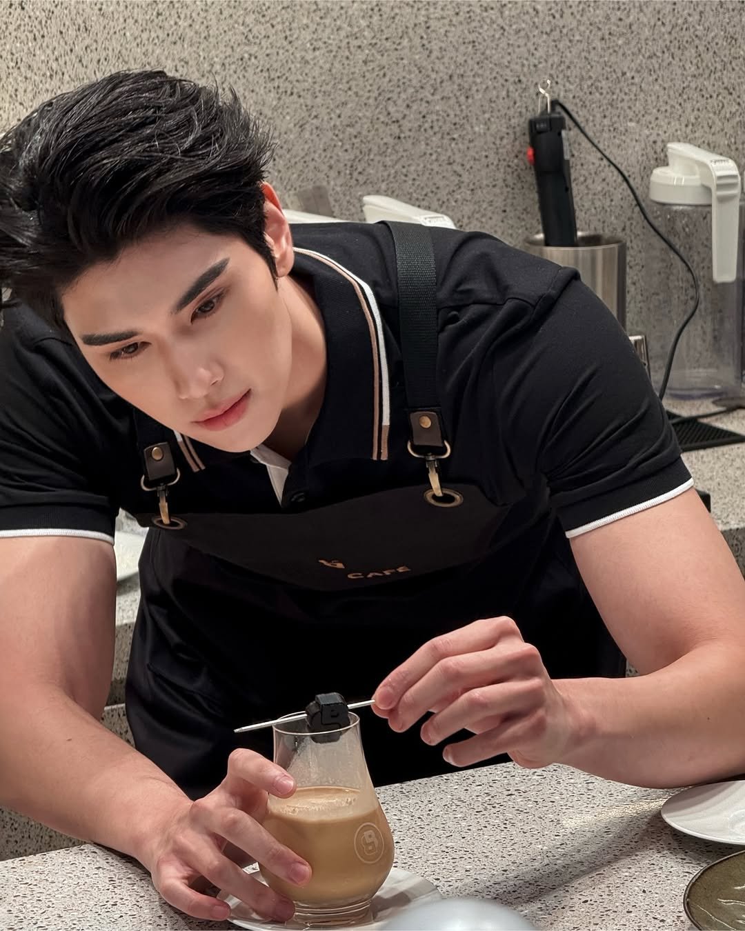 Photo shared by Dunk Natachai B. on December 02, 2025 tagging @boss. May be an image of coffee maker, drink, apron and text.