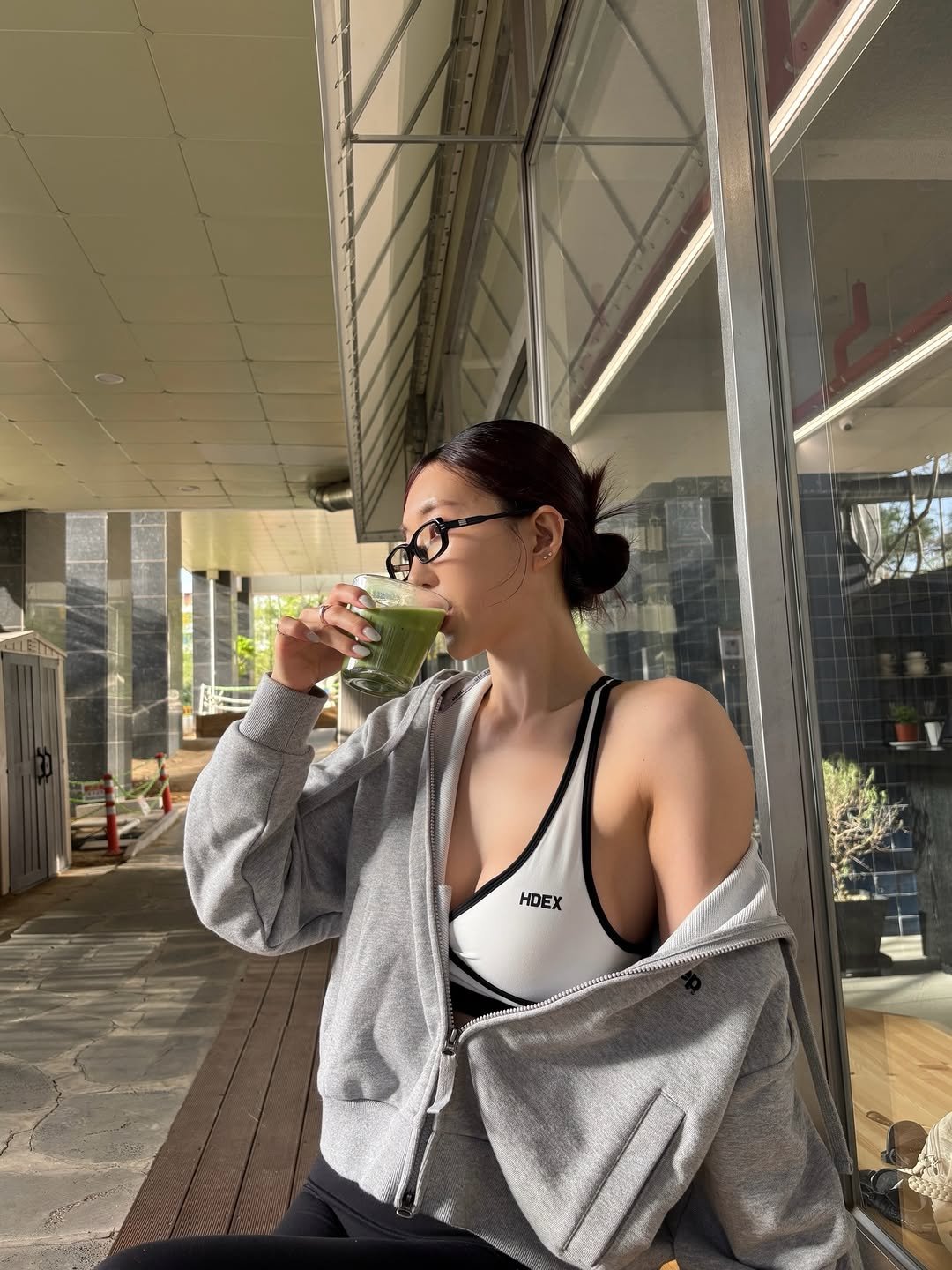 Photo shared by 이식로그🫧 on April 18, 2026 tagging @hdex__official, and @hdex_women. May be an image of activewear, sleepwear, bath robe, sweatpants, sportswear, juice, tea and text.