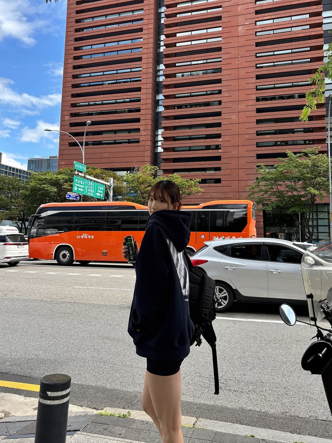 Photo shared by 이식로그🫧 on September 22, 2025 tagging @hdex__official, and @hdex_women. May be an image of 1 person, street, skyscraper, buildings and text.