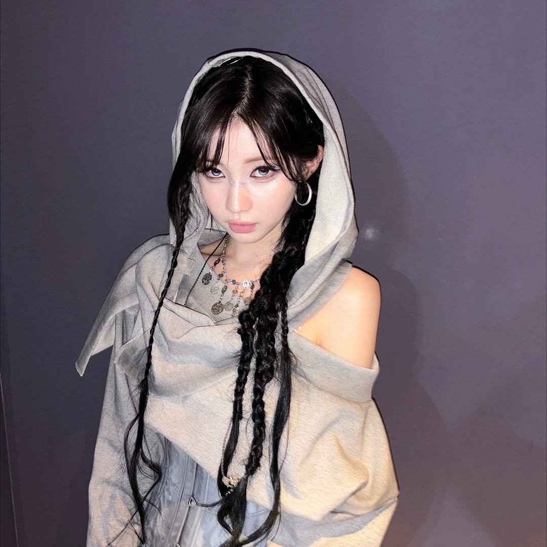 Photo by ENAMI ASA on November 16, 2025. May be an image of one or more people, braids, makeup, top, dress, cloak, parka and text.