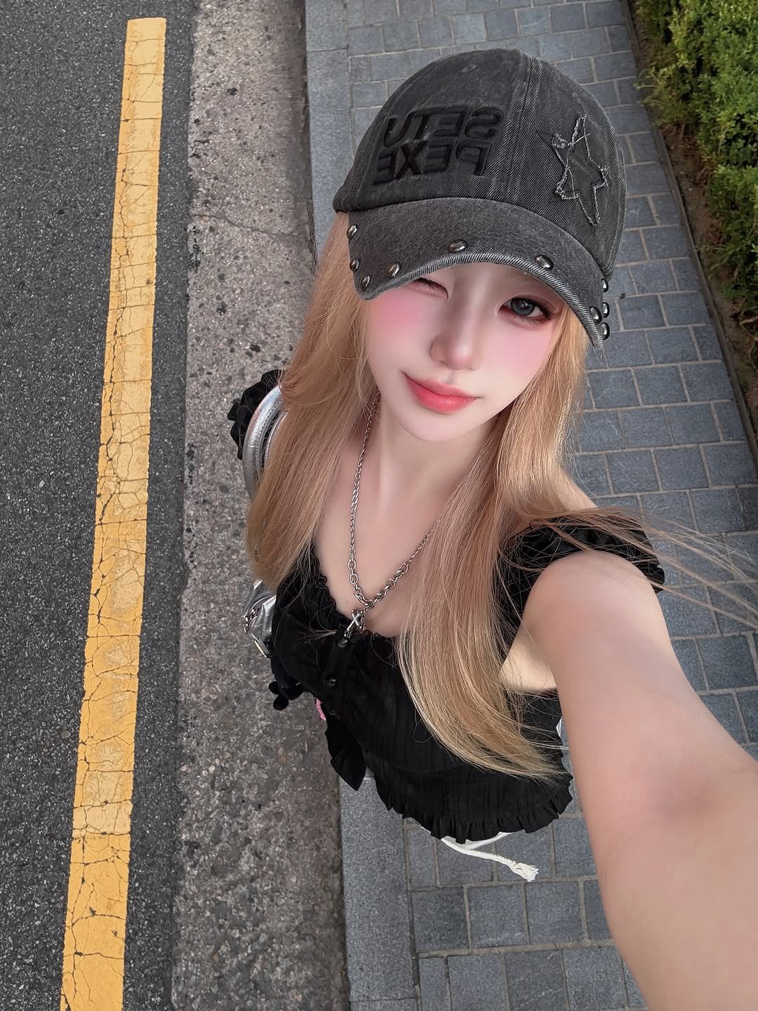 Photo shared by SUJIN ♥ on July 26, 2025 tagging @kinkybabe.official. May be a selfie of 1 person, blonde hair, hat, top, road and text.