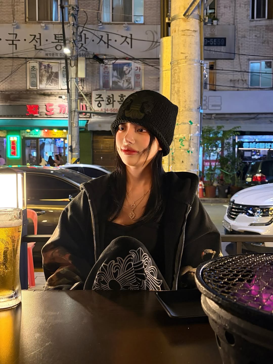 Photo by 김율 MINT on October 29, 2025. May be an image of duffle coat, parka, night and text.