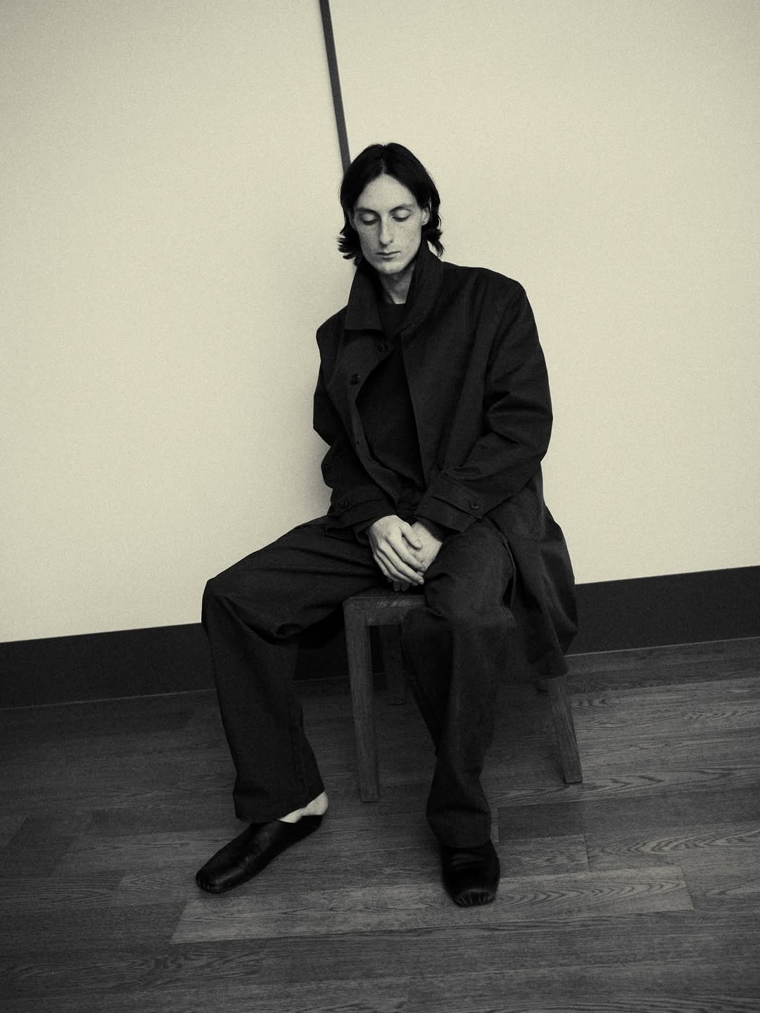 Photo by EPICENTER.TOURIST on February 27, 2026. May be a black-and-white image of duffle coat, overcoat, wingtip shoes, suit, turtleneck and text.