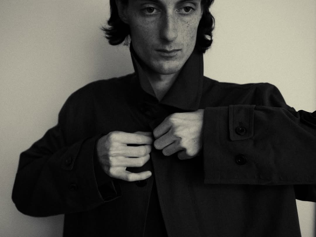 Photo by EPICENTER.TOURIST on February 27, 2026. May be a black-and-white image of one or more people, overcoat, suit and text.