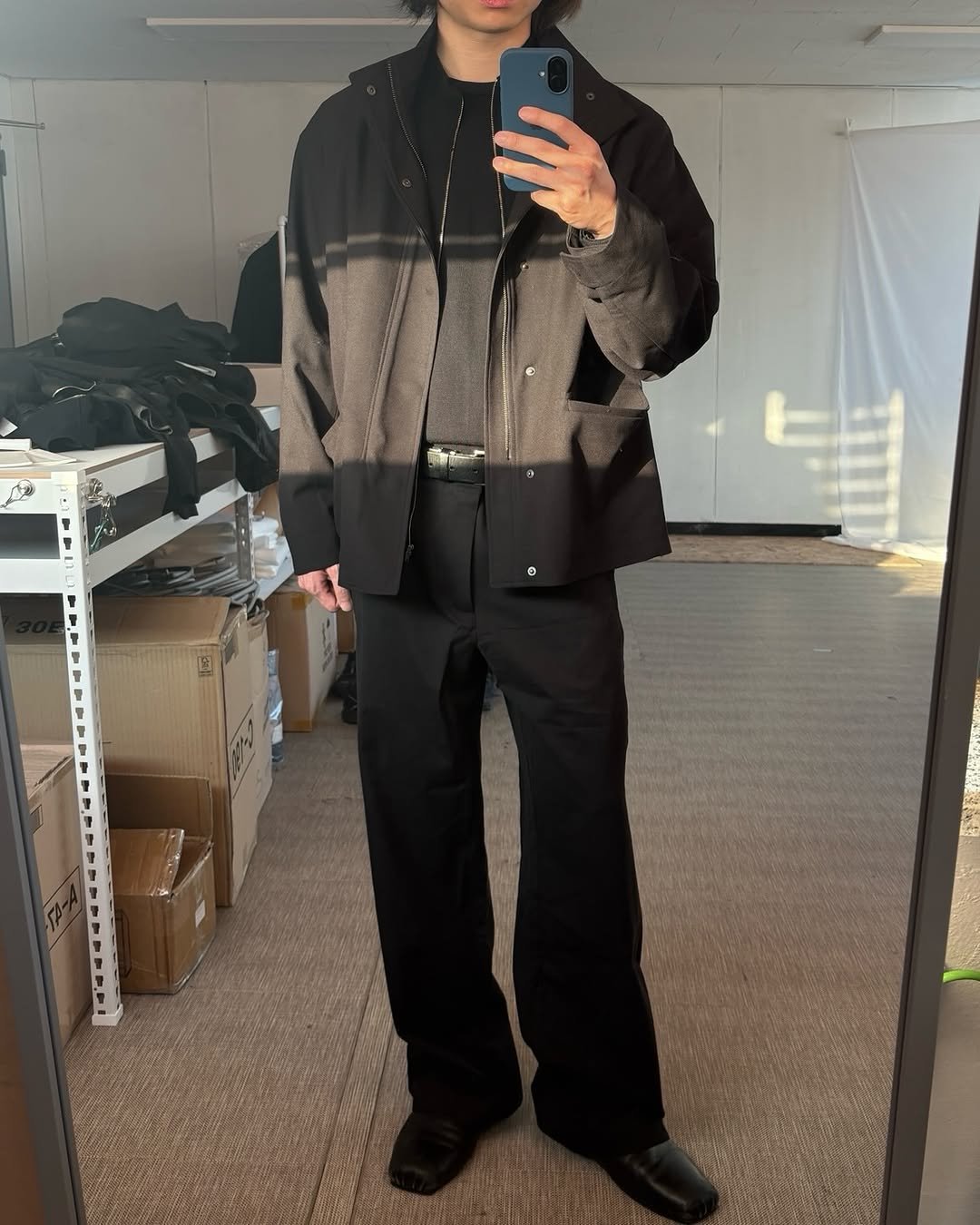 Photo by EPICENTER.TOURIST on December 05, 2025. May be an image of wingtip shoes, coat, suit, bolo tie and text.