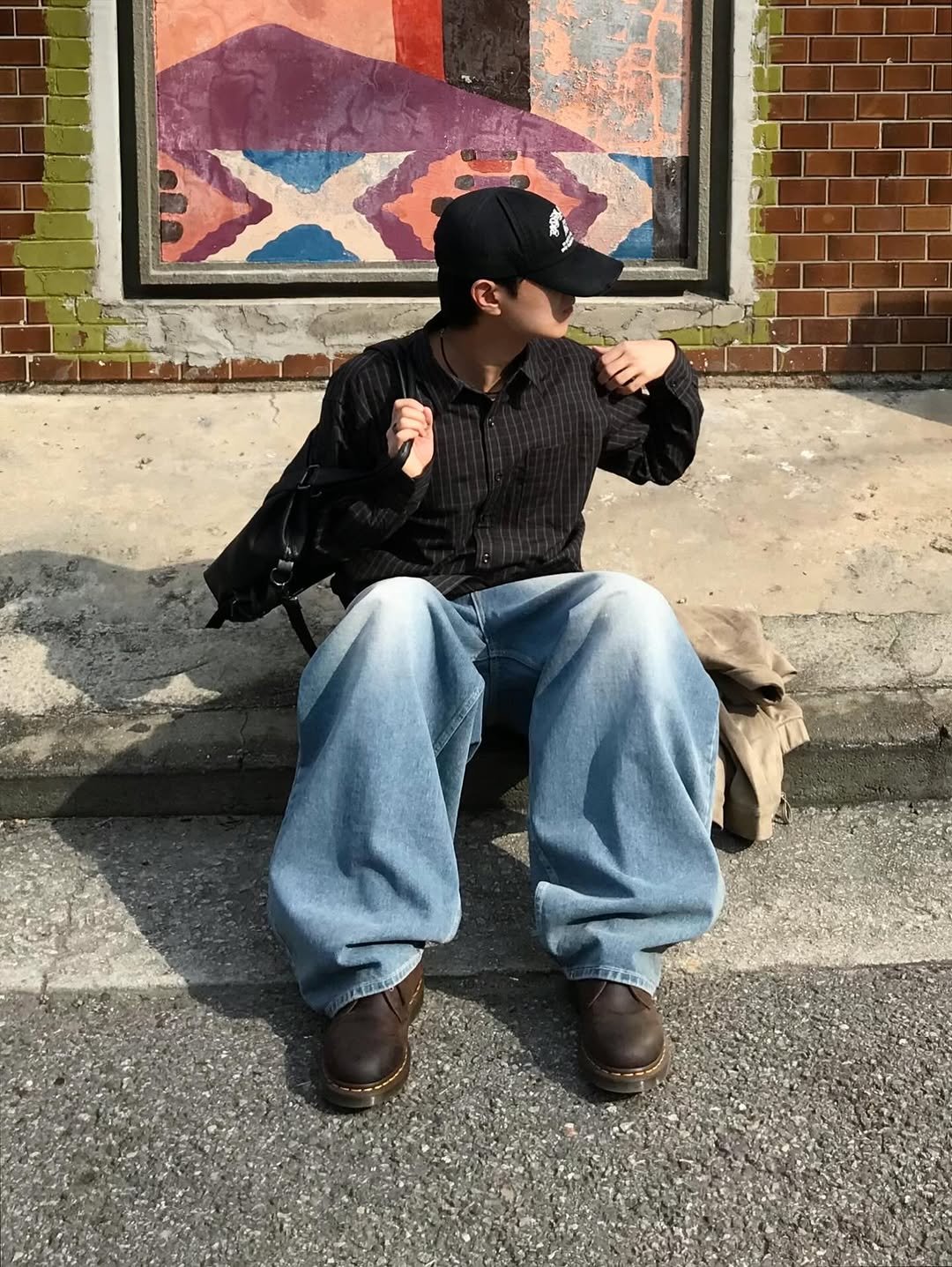 Photo shared by 동우 / 이퀄 on November 10, 2025 tagging @equal_kr. May be an image of standing, brick wall and text.