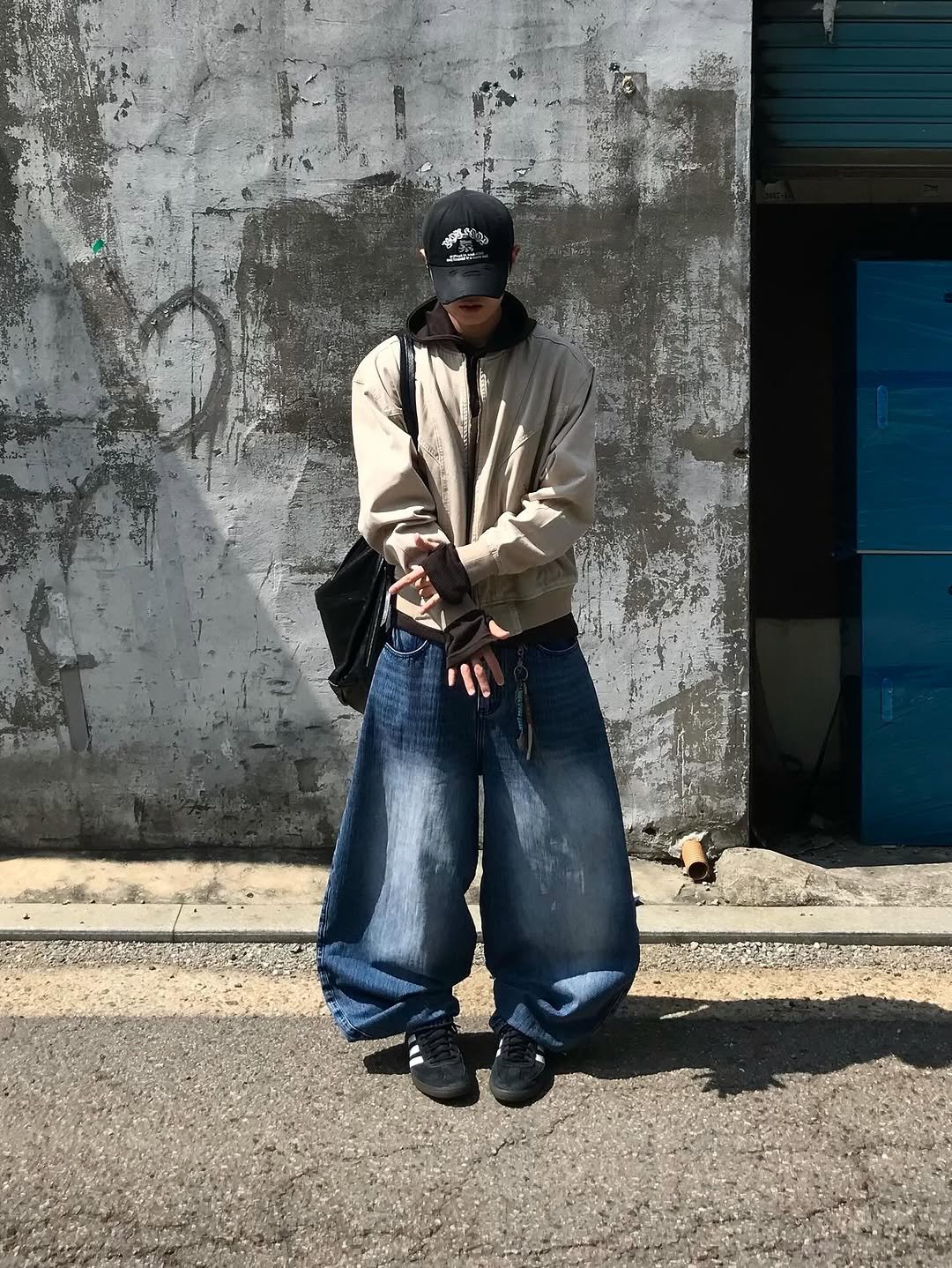 Photo shared by 동우 / 이퀄 on September 15, 2025 tagging @equal_kr. May be an image of 1 person, duffle coat, face mask, sweatpants, street and text.
