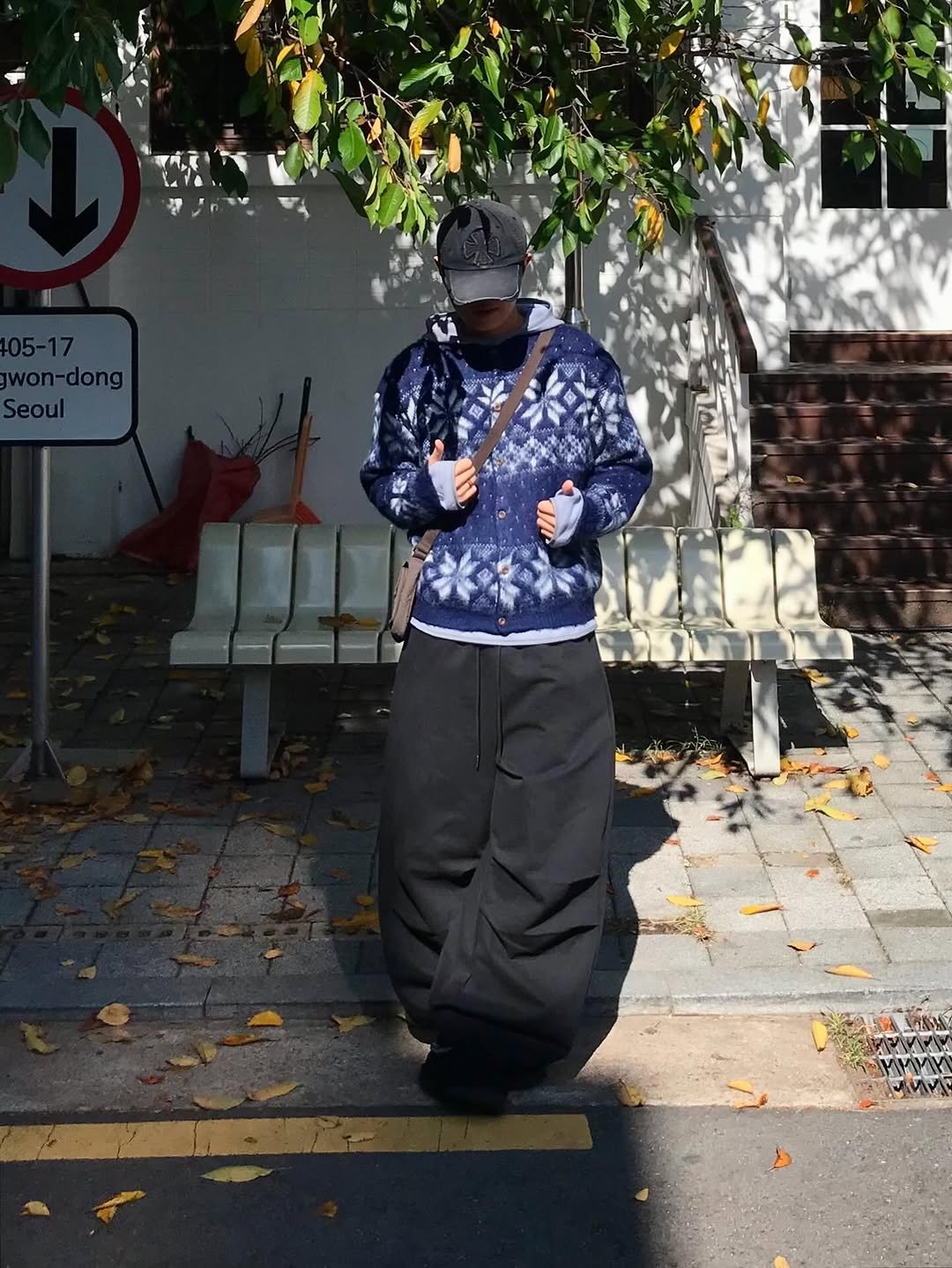 Photo shared by 동우 / 이퀄 on November 13, 2025 tagging @equal_kr. May be an image of standing, duffle coat, face mask, parka, sweatsuit, fleece, sweatpants, street and text.