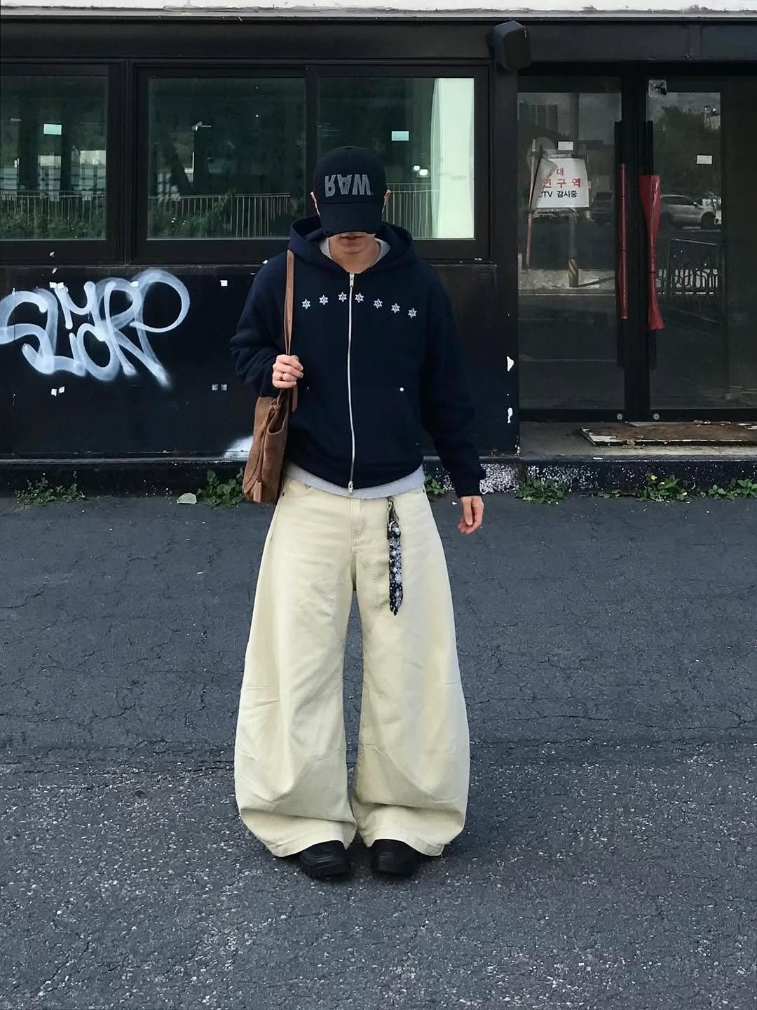 Photo shared by 동우 / 이퀄 on November 07, 2025 tagging @equal_kr. May be an image of duffle coat, overcoat, parka, sweatpants, street and text.