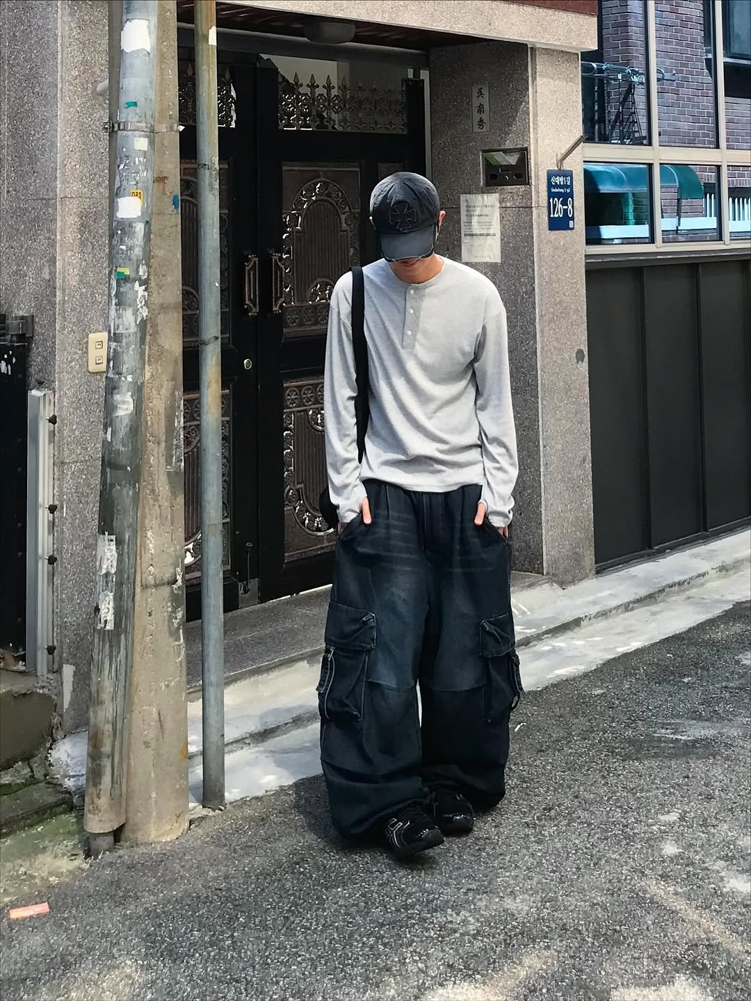 Photo shared by 동우 / 이퀄 on September 22, 2025 tagging @equal_kr. May be an image of 1 person, skateboard, goosedown coat, duffle coat, parka, sweatpants, sportswear, street and text.