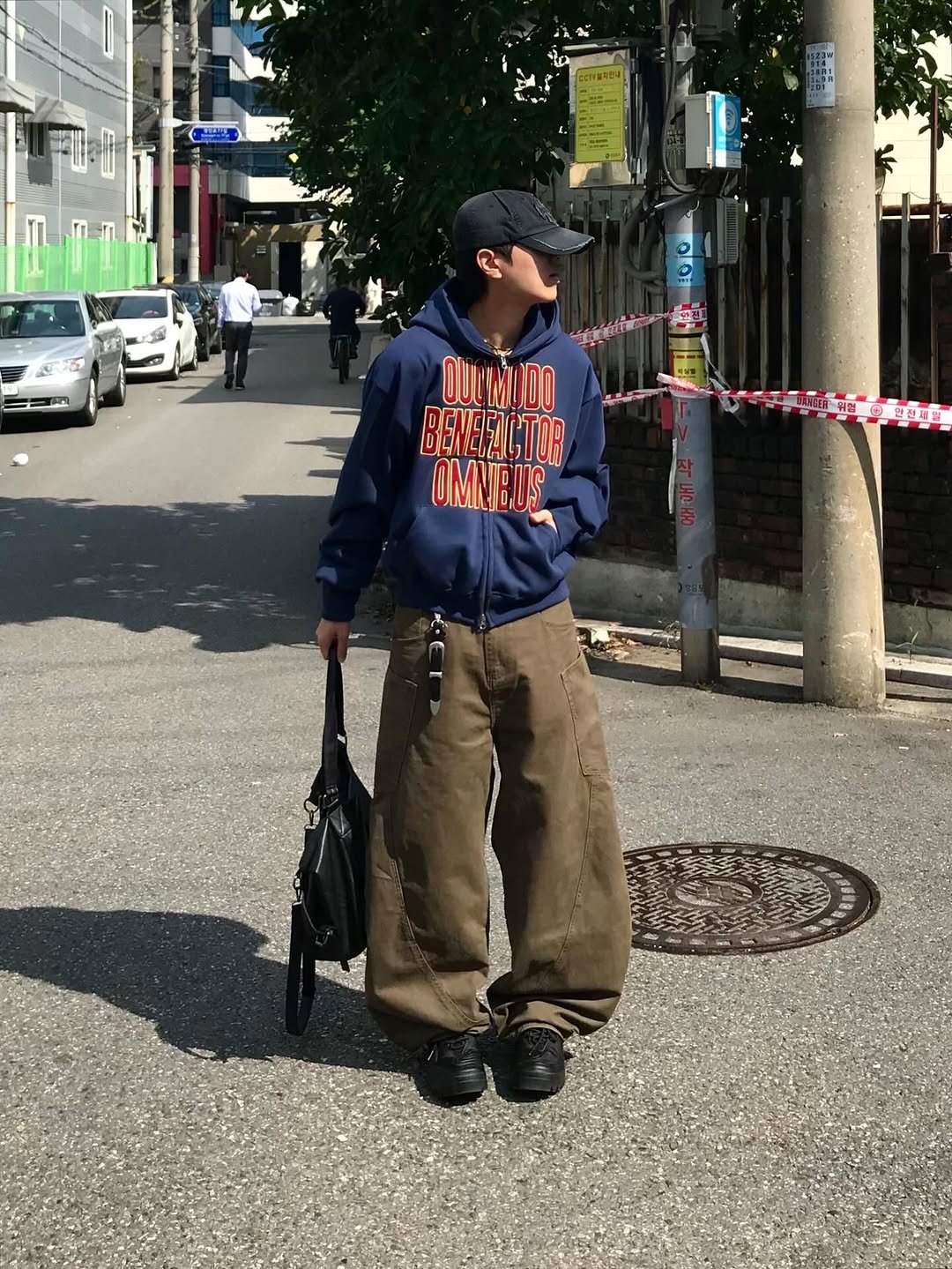 Photo shared by 동우 / 이퀄 on October 27, 2025 tagging @equal_kr. May be an image of duffle coat, parka, sweatpants, street and text.