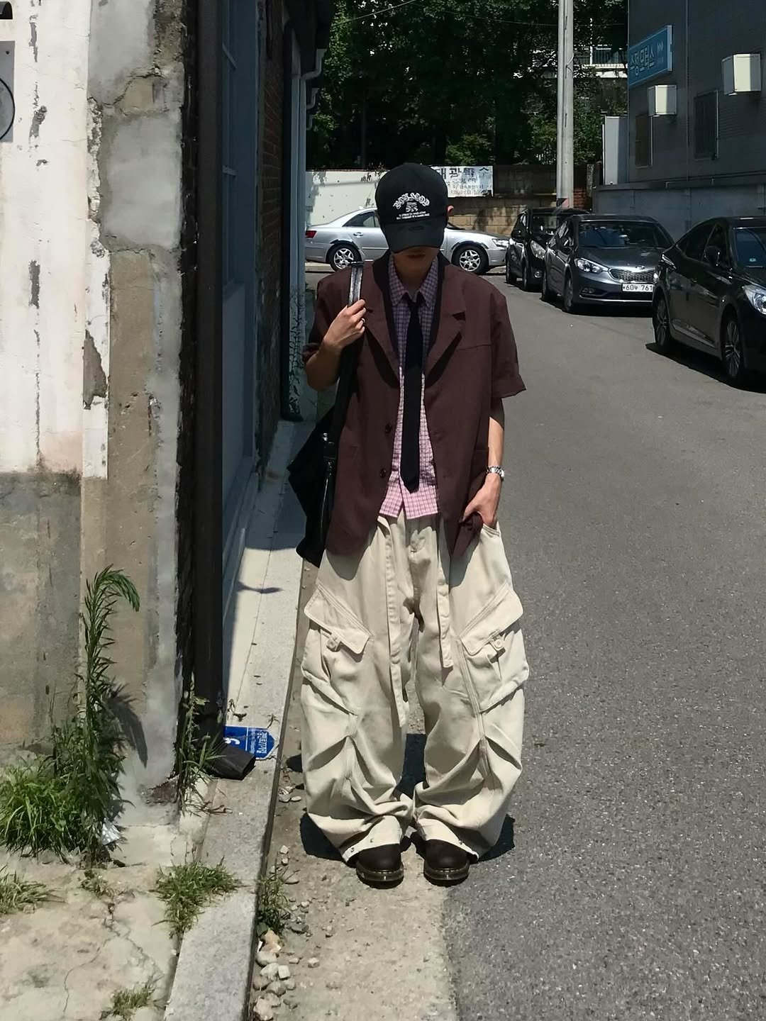 Photo shared by 동우 / 이퀄 on August 10, 2025 tagging @equal_kr. May be an image of 1 person, smoking, street and text.