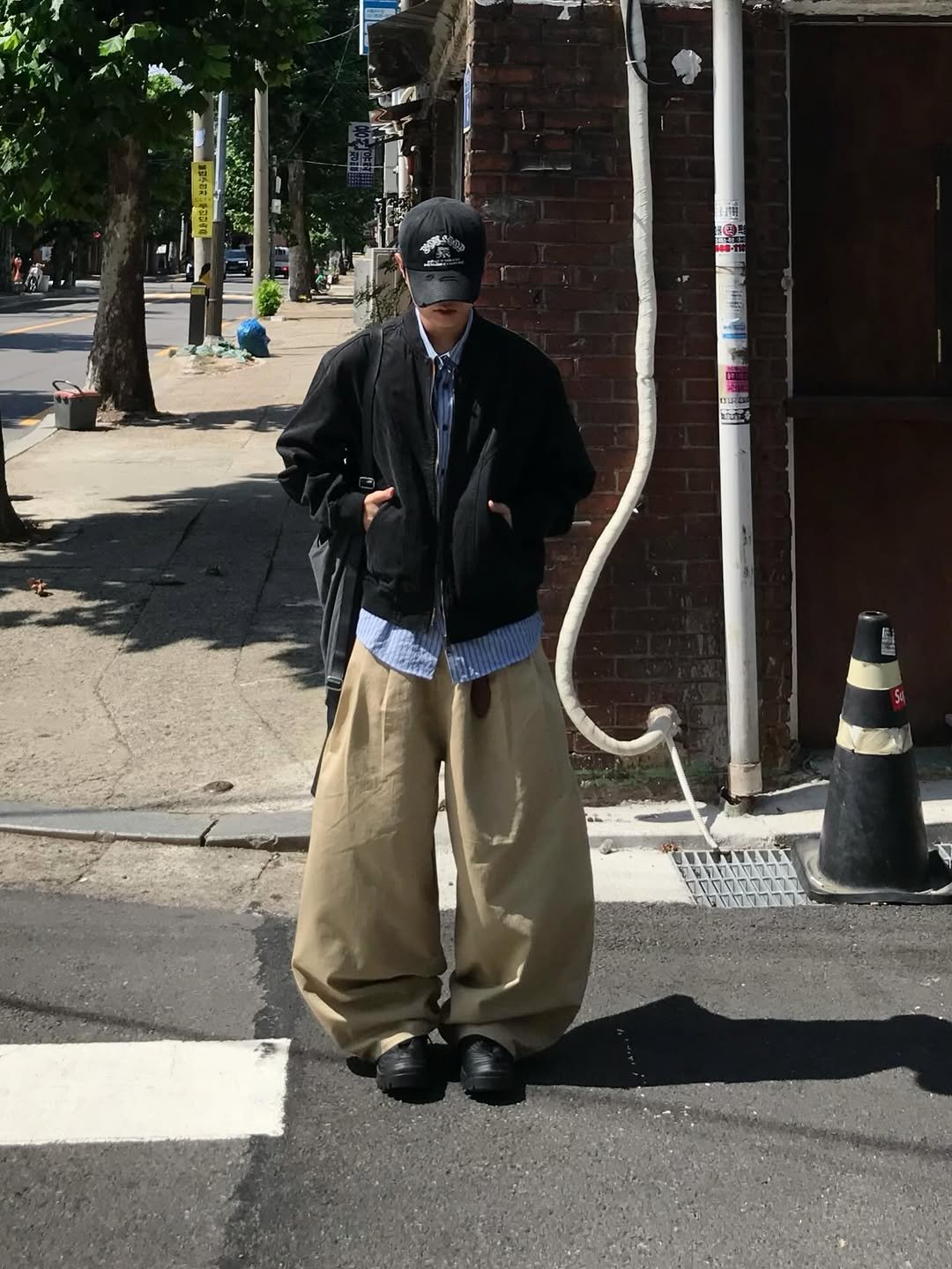 Photo by 동우 / 이퀄 on September 10, 2025. May be an image of 2 people, parking meter, street, telephone pole and text.