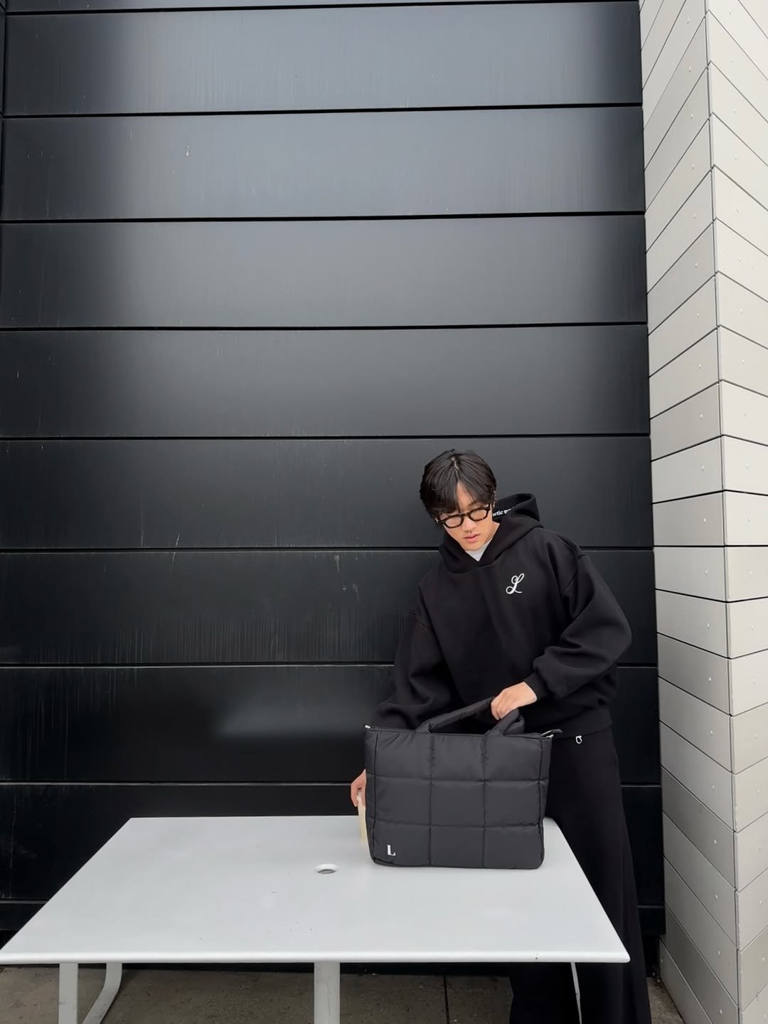 Photo shared by eric park on March 14, 2026 tagging @leftfieldclo. May be an image of duffle coat, overcoat, tool bag, briefcase, cornflower and text.