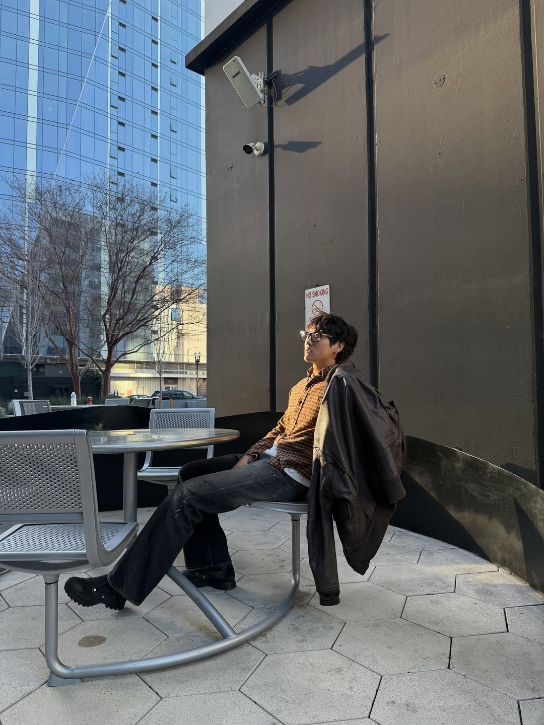 Photo by eric park on March 15, 2026. May be an image of duffle coat, overcoat, cigarette and text.