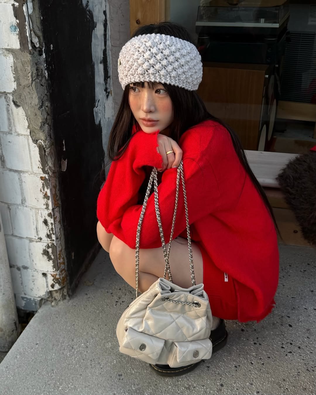 Photo by Eunji Hong on December 02, 2025. May be an image of duffle coat, hat, headscarf, beret, fur, knit, sweater, purse, turban and text.