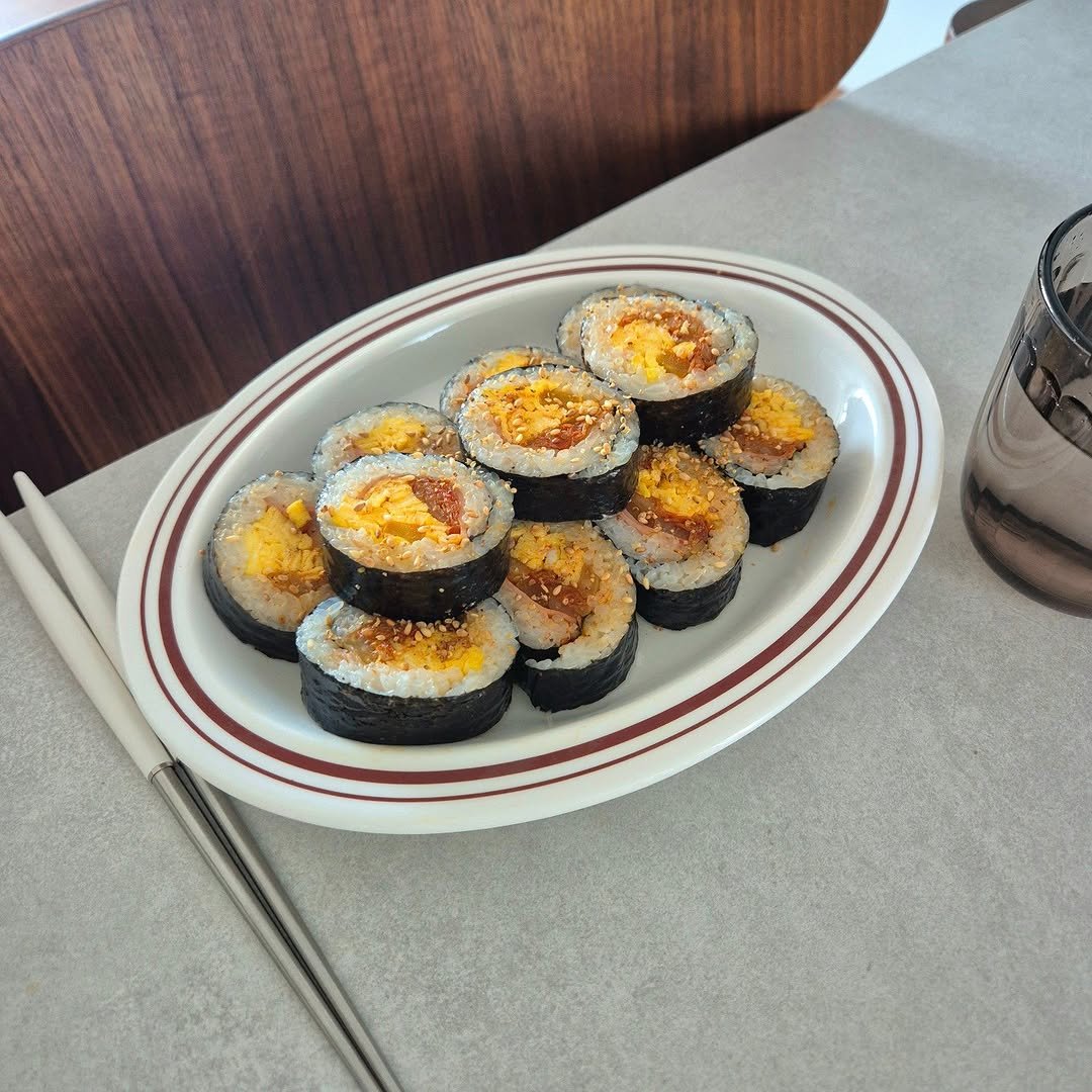 Photo by 은하수 on February 18, 2026. May be an image of sushi, roe, caviar, seaweed, rice, chopsticks, boiled egg and text.