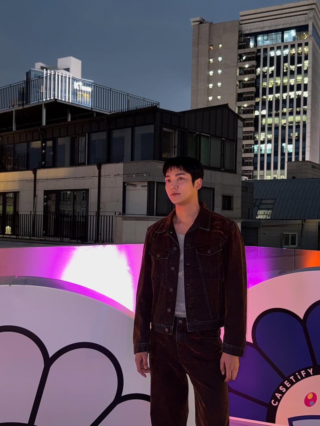 Photo shared by 로운 on September 26, 2025 tagging @casetify. May be an image of duffle coat, overcoat and text.