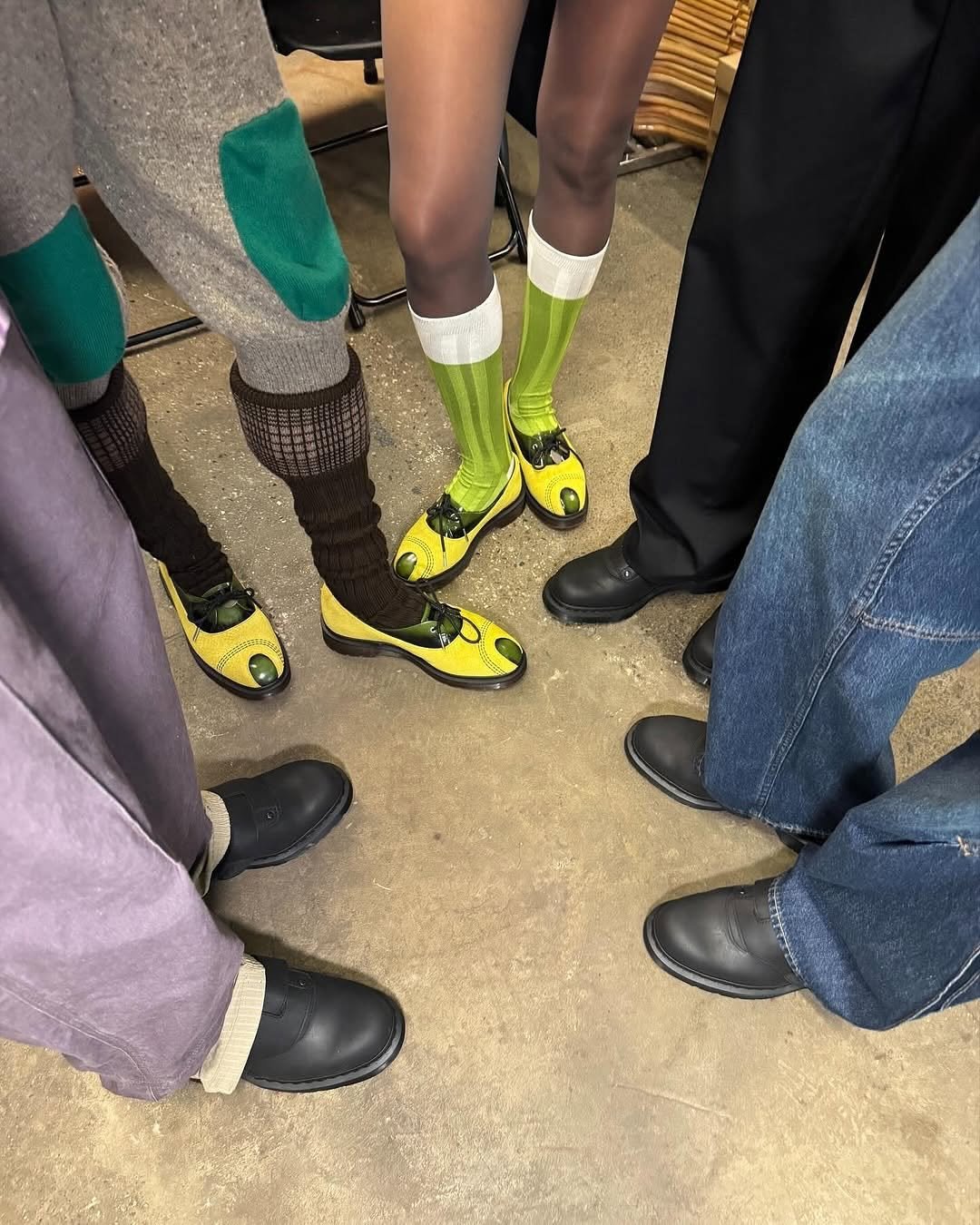 Photo shared by eyesmagazine 아이즈매거진 on November 16, 2025 tagging @drmartensofficial, and @kikokostadinov. May be an image of wingtip shoes, tights, sock, boots, kilt and text.