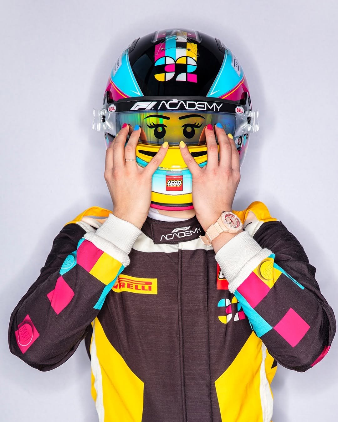 Photo shared by TAG Heuer on April 26, 2026 tagging @lego, @esmee_kosterman, and @f1academy. May be an image of ‎racing vehicles, face mask, helmet, glasses and ‎text that says '‎FINCADEMY BELL LEGO عم 15 NCDEM DEMN RELLI‎'‎‎.
