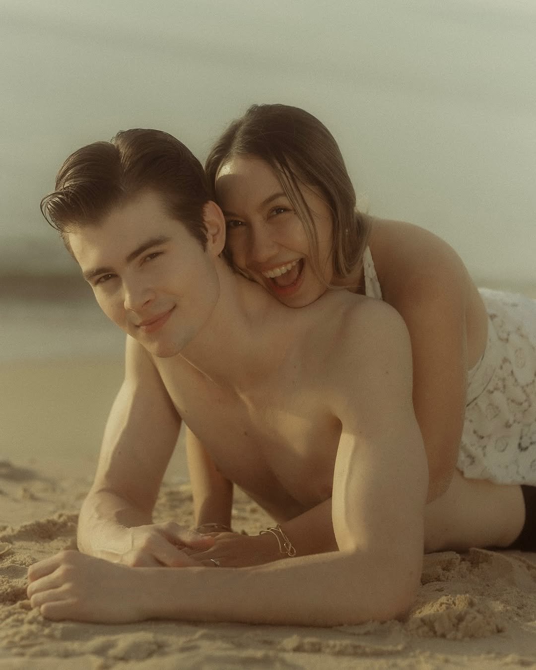 Photo by Ruslan Mamlay on November 12, 2025. May be an image of one or more people, people kissing, beach and text.