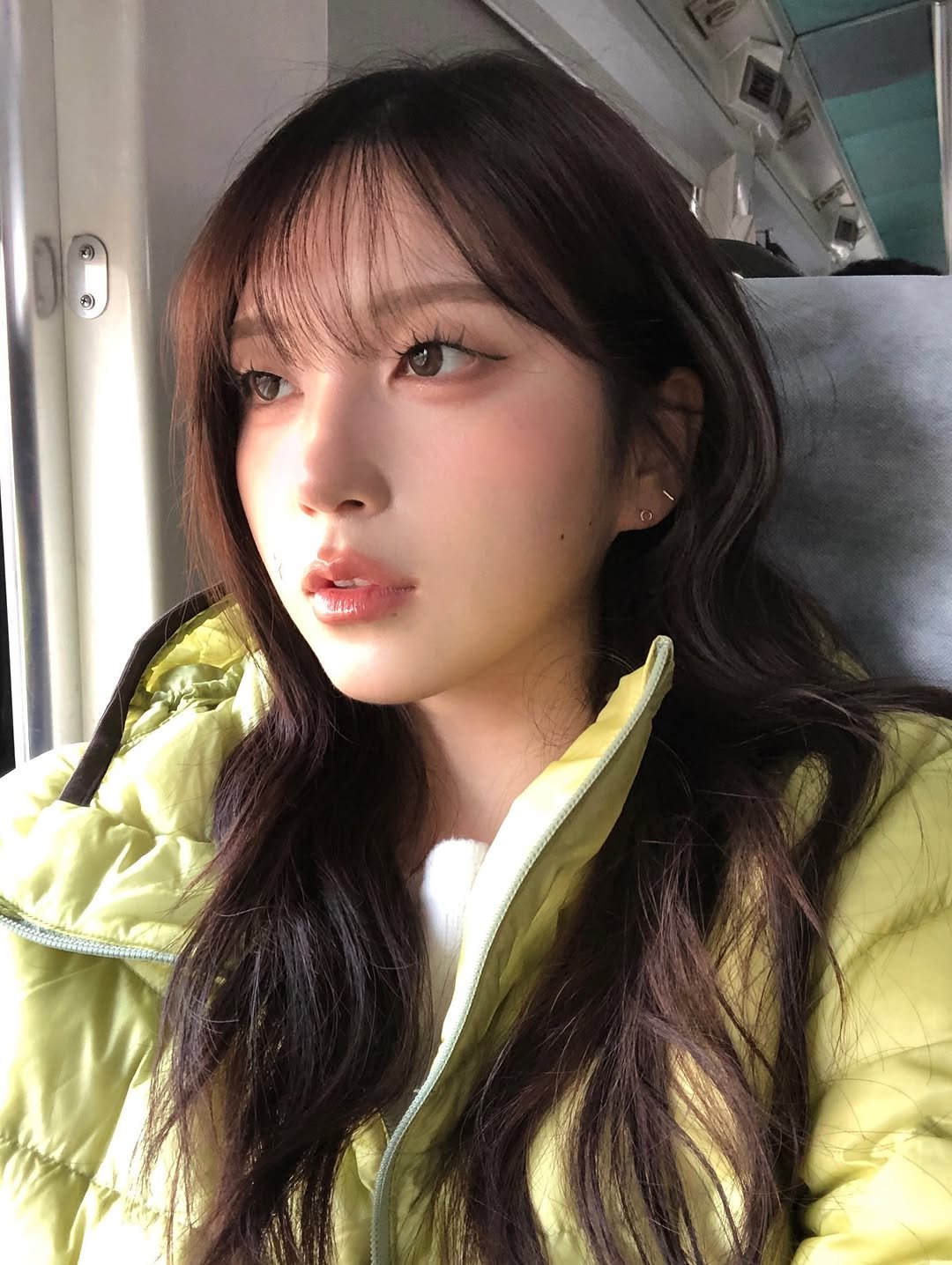 Photo by 동화 on November 14, 2025. May be an image of one or more people, hair, parka, bus and text.