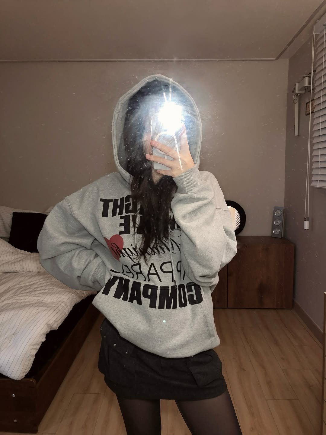 Photo by 동화 on December 04, 2025. May be an image of tights, sweatshirt, sweater, miniskirt, mirror, sweatpants, fishnet stockings and text.