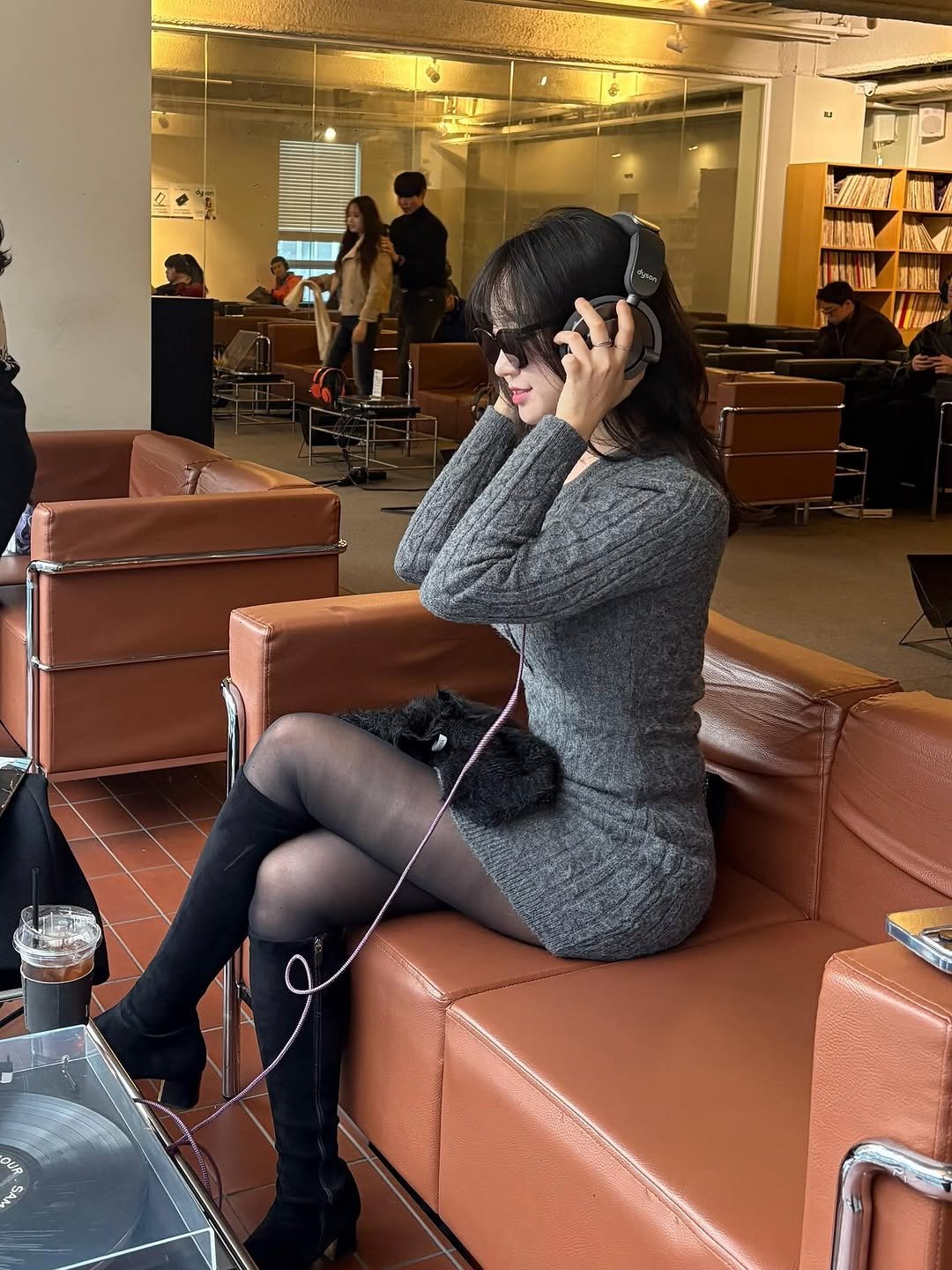 Photo shared by 묘정🐰 on December 24, 2025 tagging @vinyl_seongsu. May be an image of studying, phone, hair dryer, knit, armchair, telephone, office and text.