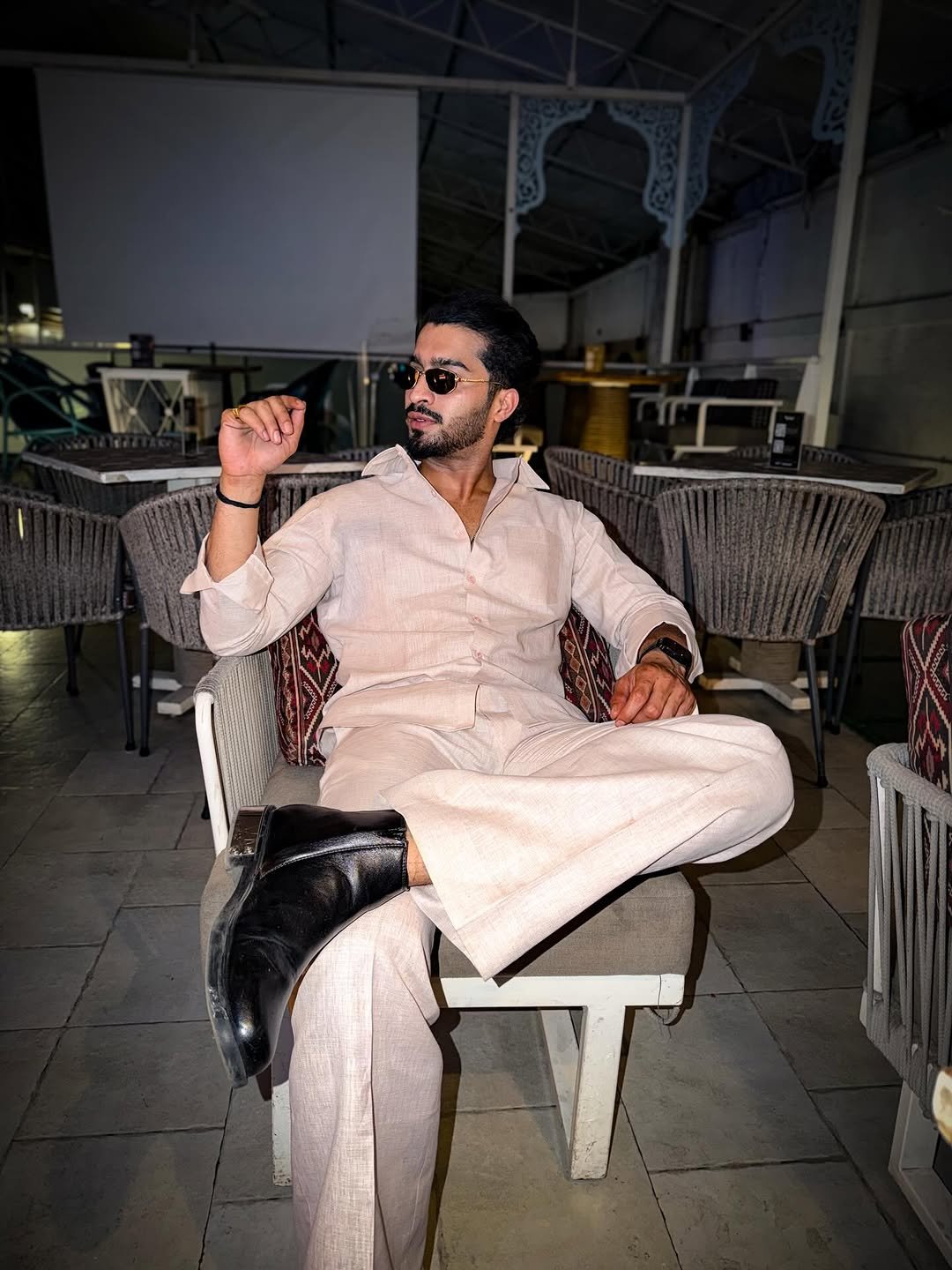 Photo shared by Faiz Baloch on March 13, 2026 tagging @paak.pehnawa.mens. May be an image of one or more people, beard, suit, overcoat, wingtip shoes, blazer, cigar and text.