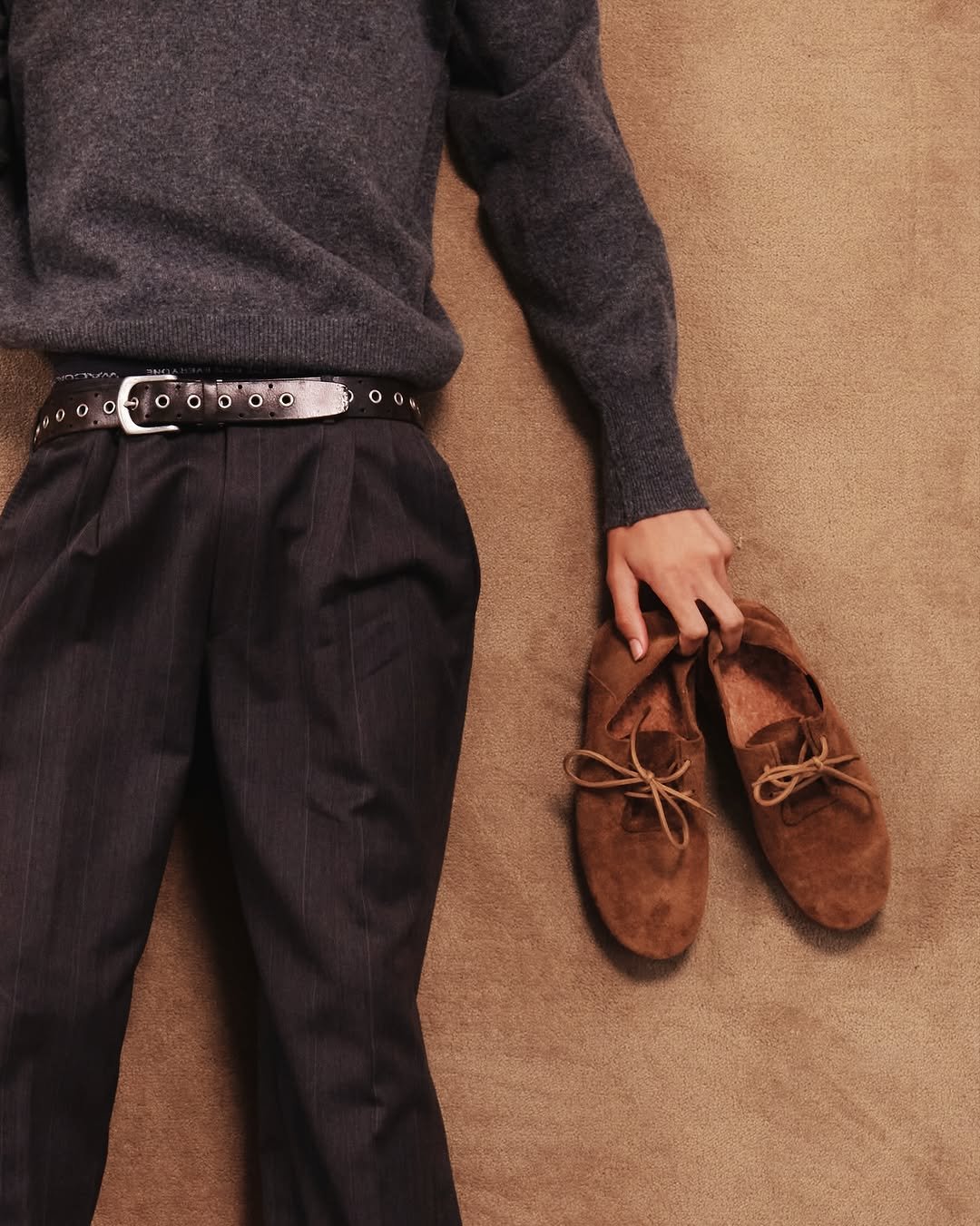 Photo shared by fake magazine 페이크 매거진 on November 13, 2025 tagging @musinsa.official, and @kinchi_official. May be an image of wingtip shoes, sweater, belt, bolo tie and text.
