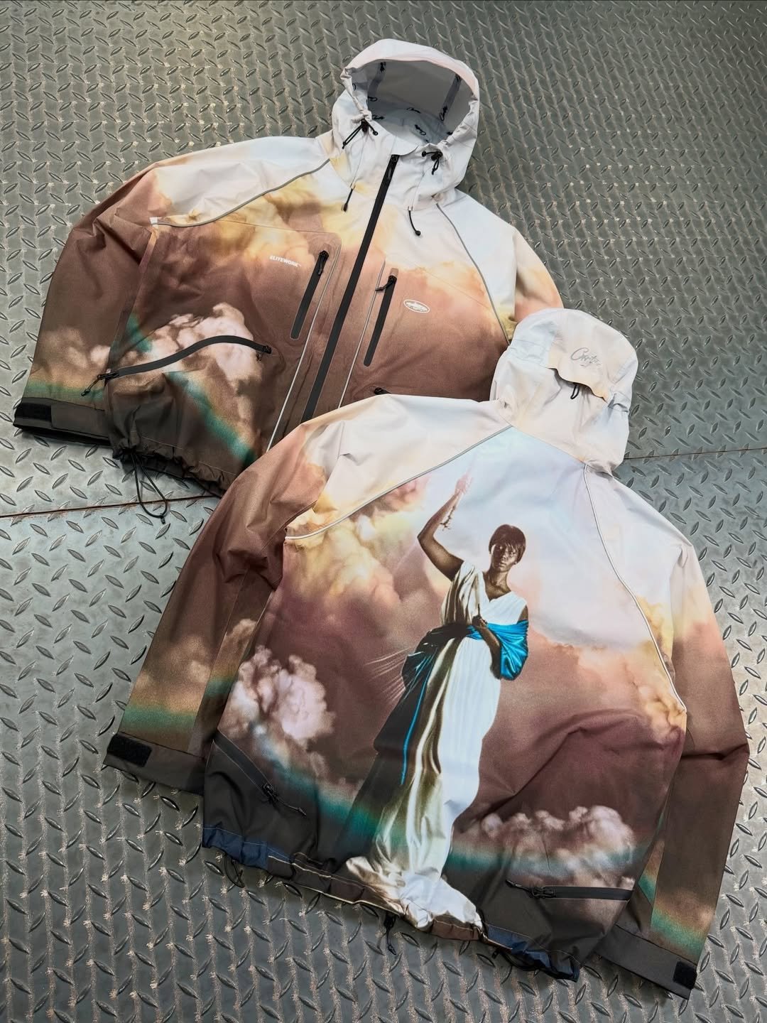 Photo shared by fake magazine 페이크 매거진 on April 27, 2026 tagging @clint419, and @corteiz. May be an image of sweatshirt, drawstring, raincoat, parka, flight jacket and text.