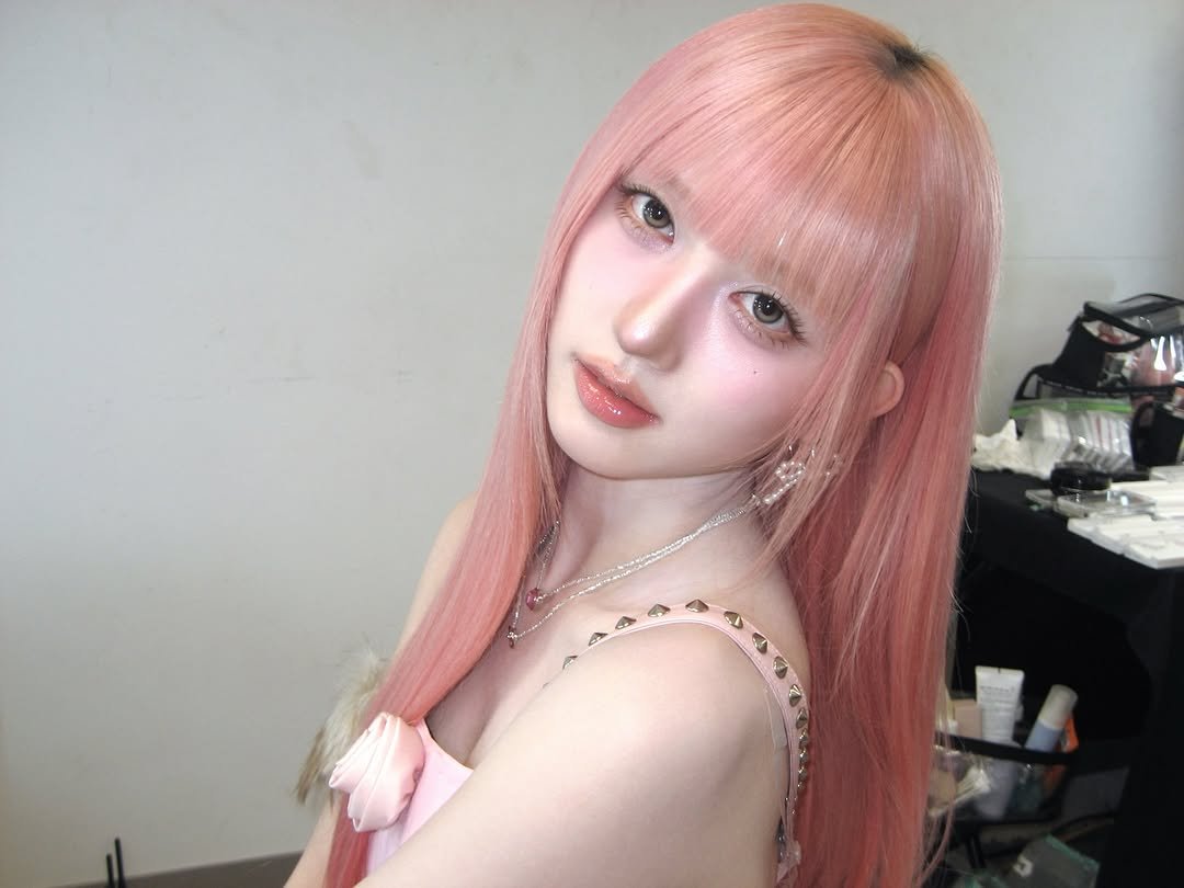 Photo by 가을 GAEUL on January 16, 2026. May be an image of one or more people, blonde hair, braids, bangs, long hair, makeup and text.