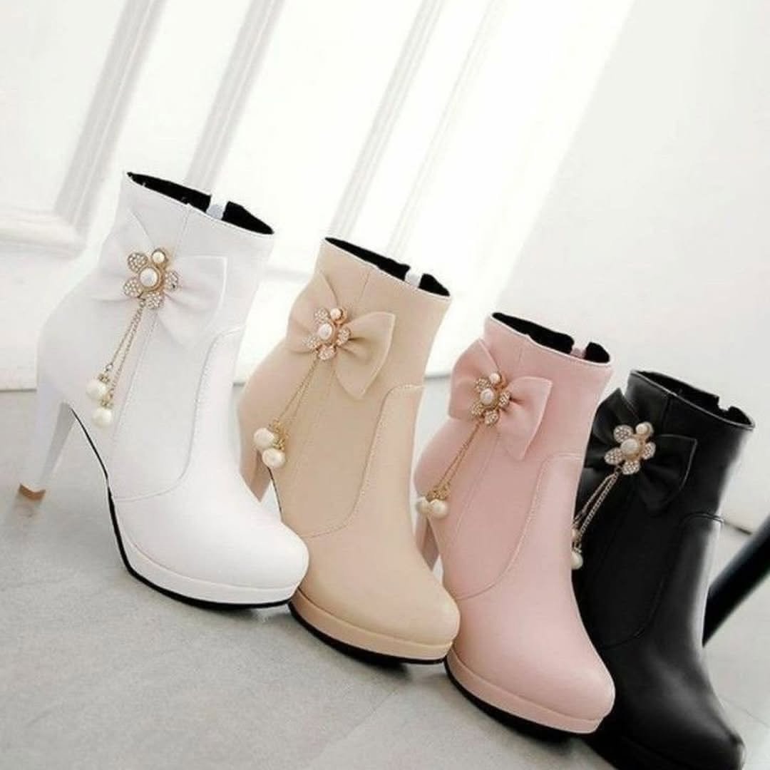 Photo by Fashion Explored on November 14, 2025. May be an image of boots, high-heeled shoes, slingback shoes, baby shoes and text.