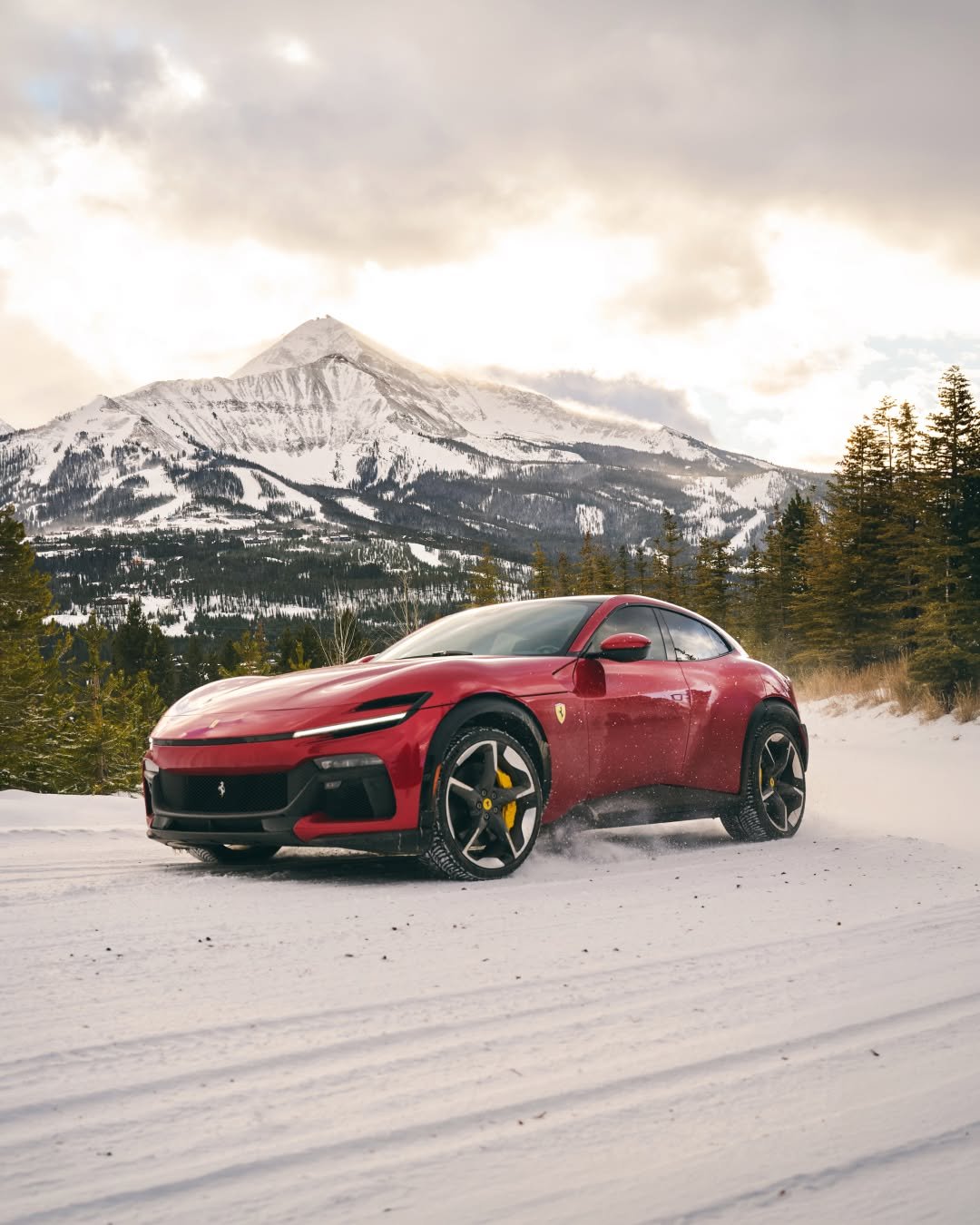 Photo shared by Ferrari on April 22, 2026 tagging @ferrariusa. May be an image of race car, wheel, blower, road, snow and text.