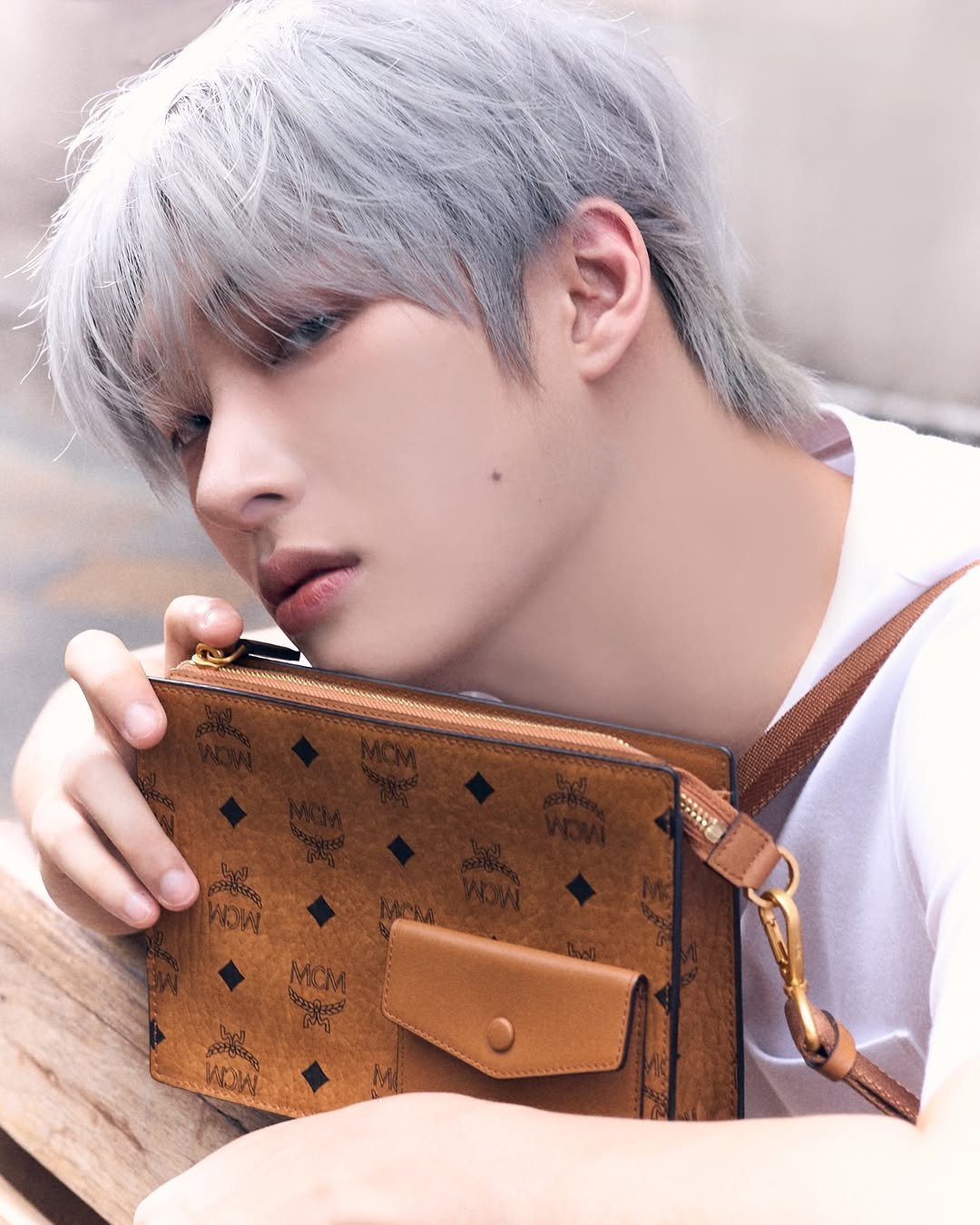 Photo shared by 민기 (MINGI) on March 27, 2026 tagging @mcmworldwide. May be an image of one or more people, bangs, bolo tie and text.