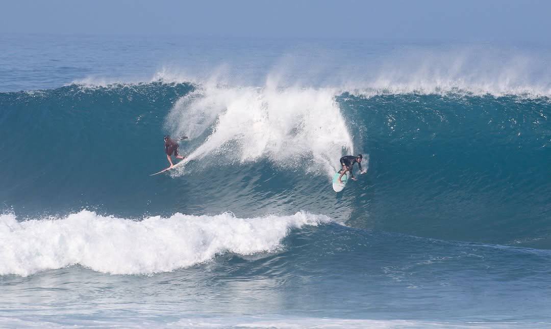 Photo by Pete Hodgson on November 27, 2025. May be an image of surfboard, wetsuit, ocean, water and text.