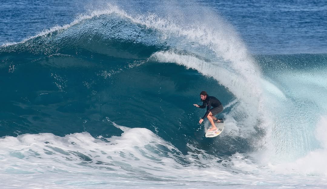 Photo by Pete Hodgson on December 04, 2025. May be an image of surfboard, wetsuit, water, ocean and text.