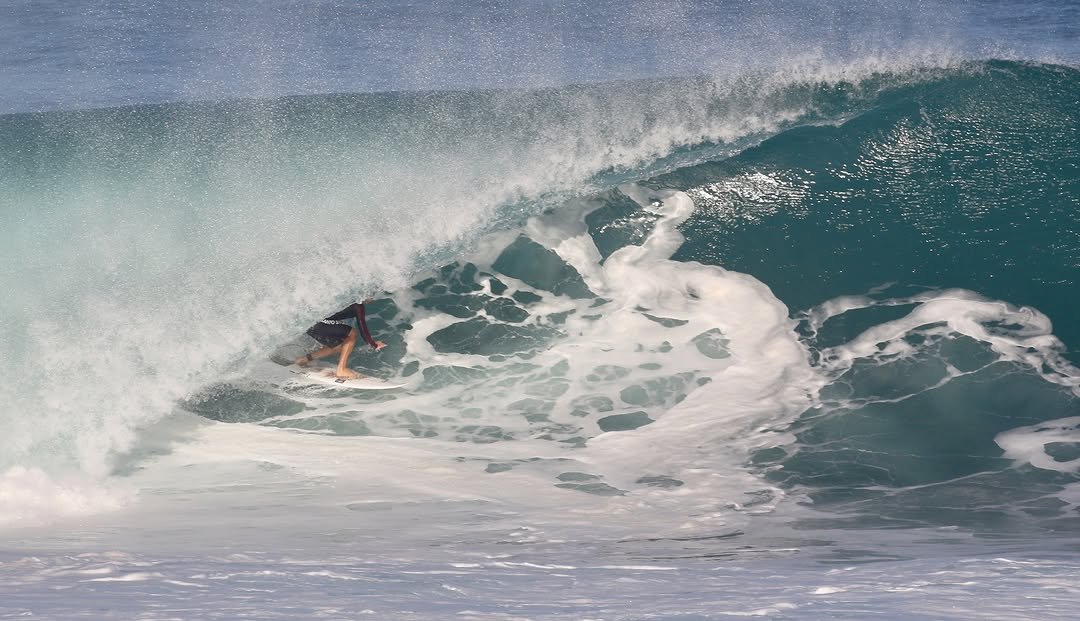 Photo by Pete Hodgson on December 02, 2025. May be an image of surfboard, wetsuit, ocean, water and text.
