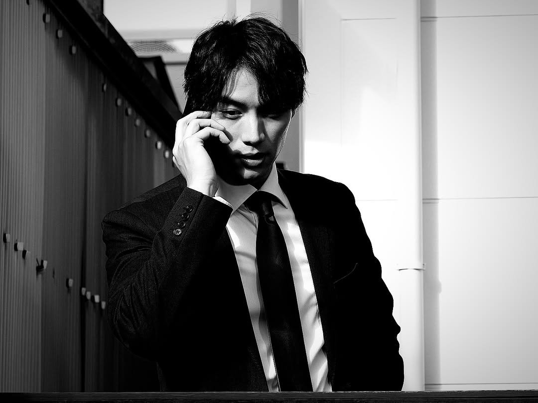 Photo by Sota Fukushi on March 03, 2026. May be a black-and-white image of one or more people, suit and text.