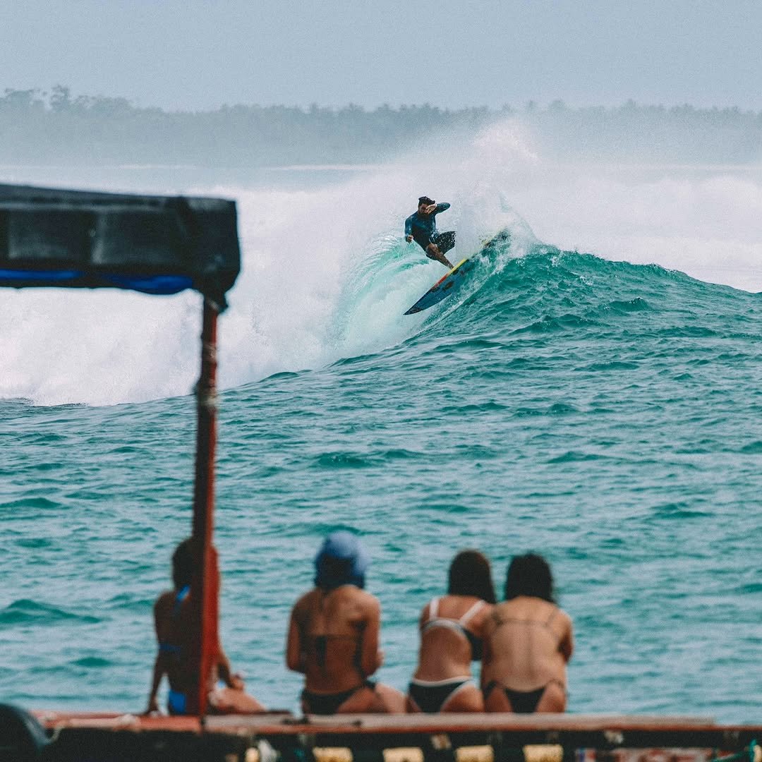 Photo shared by Gabriel Pastori on April 13, 2026 tagging @caits92. May be an image of surfboard, wetsuit, ocean, water, beach and text.