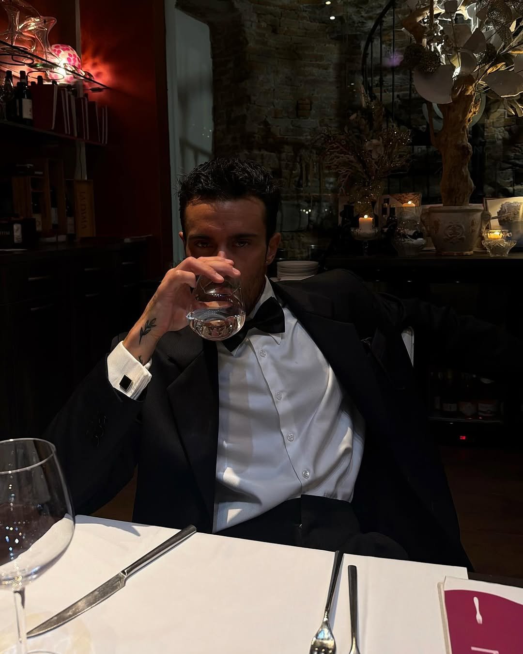 Photo by ga on September 25, 2025. May be an image of 1 person, suit, wine glass, dinner jacket and text.