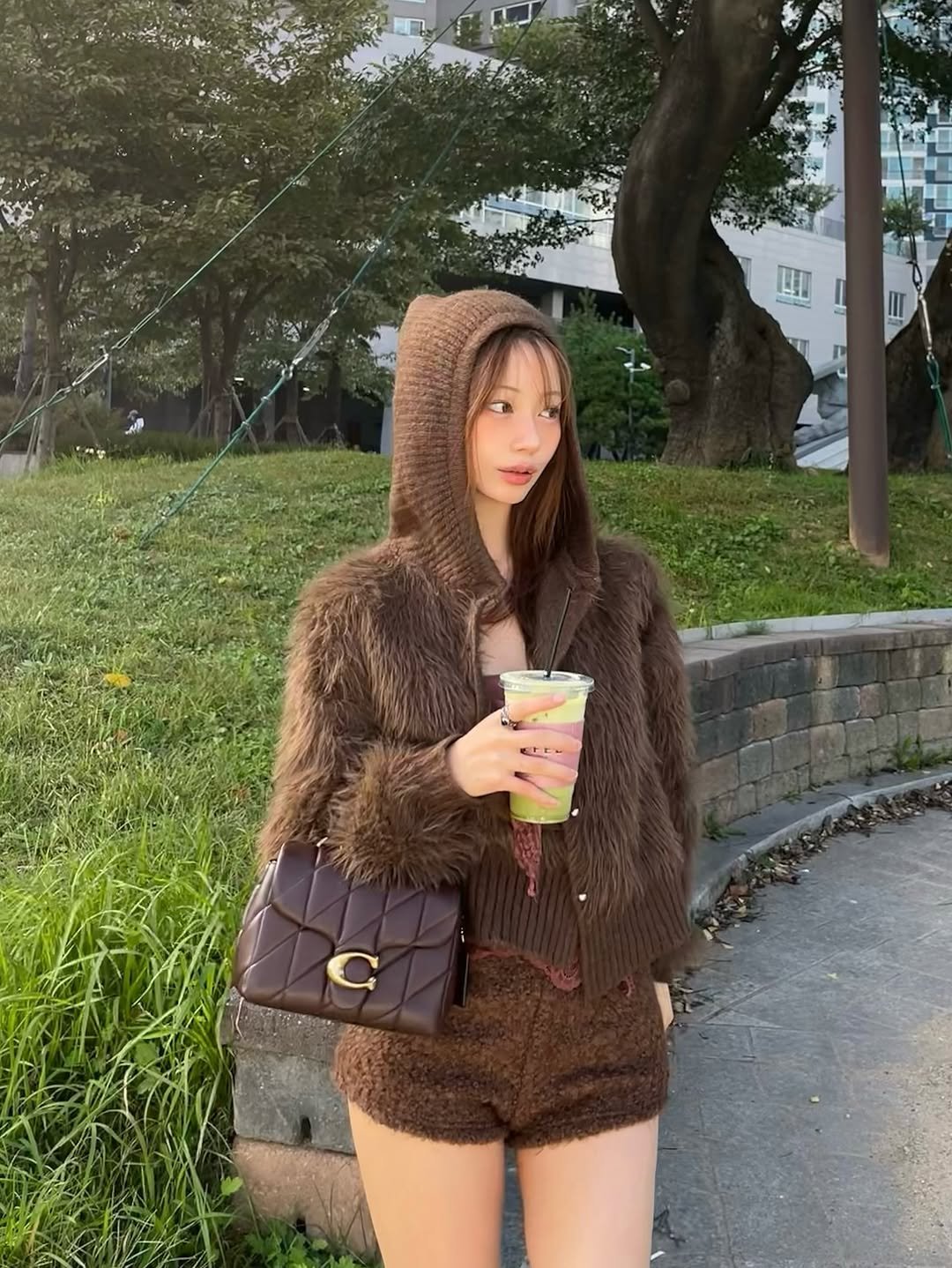 Photo shared by 은진 on October 26, 2025 tagging @coach. May be an image of fur coat, parka and text.