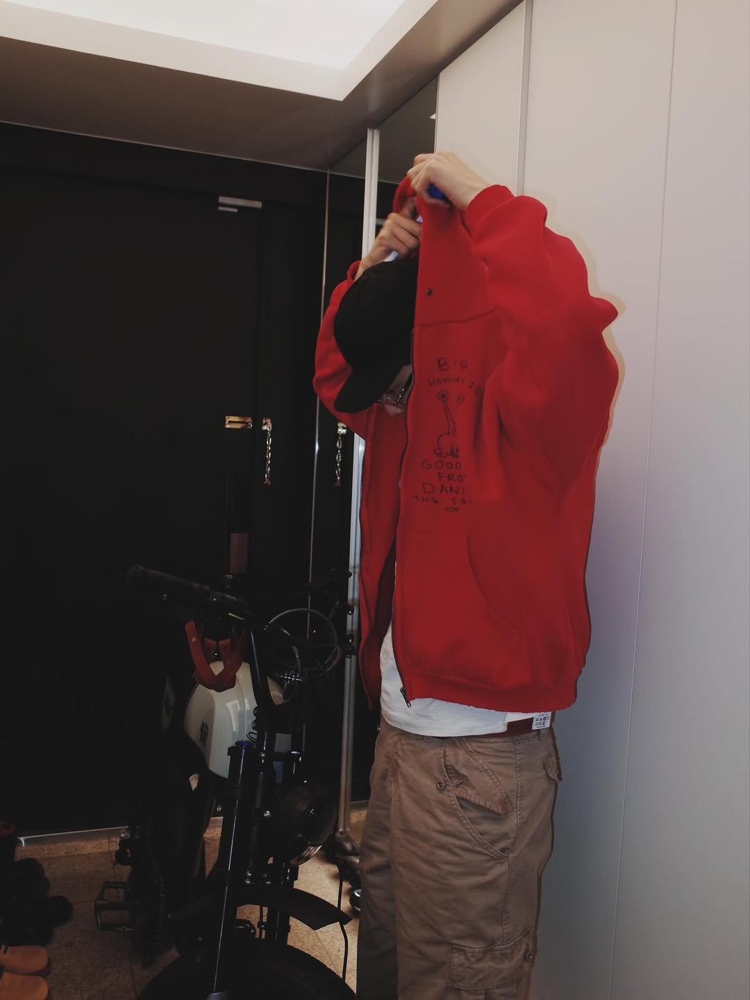 Photo shared by 기리보이 WSH on December 13, 2025 tagging @thisisneverthat. May be an image of face mask, parka, jacket and text.