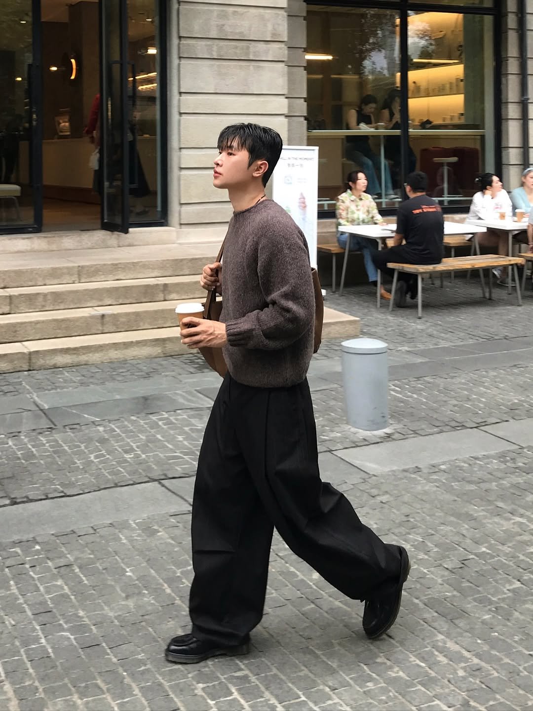 Photo by 기민 / 기틀 on October 28, 2025. May be an image of one or more people, duffle coat, overcoat, turtleneck, cornflower, street and text.