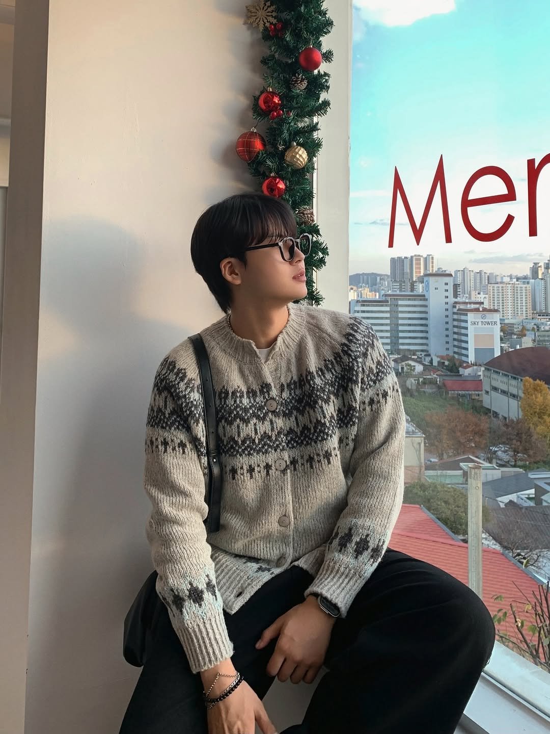 Photo shared by Good Look 굿룩 on November 23, 2025 tagging @t.o_y.o. May be an image of one or more people, hair, christmas tree, sweater, turtleneck and text.
