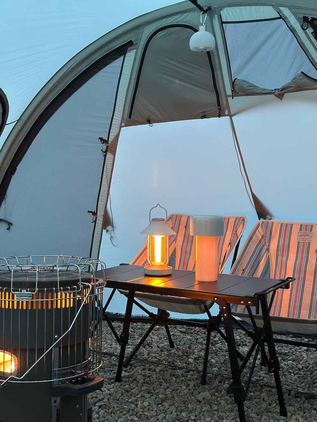 Photo shared by 루나의 캠핑&살림 on December 28, 2025 tagging @lumena__official. May be an image of campsite, stove, tent, lantern, deck chair, outdoors and text.