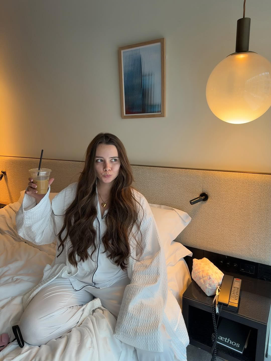 Photo shared by grace tutty on November 09, 2025 tagging @hera.women, and @girluniformco. May be an image of sleepwear, bed, bath robe, robe, bedroom, indoors and text.