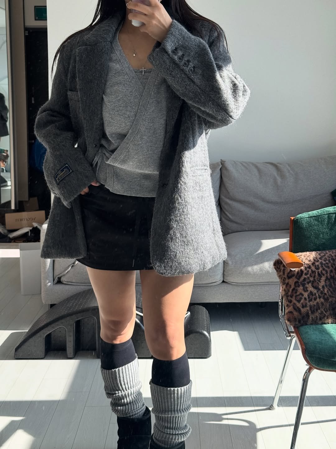 Photo by 건장걸 on November 23, 2025. May be an image of parka, miniskirt, cardigan, boots, fur and text.