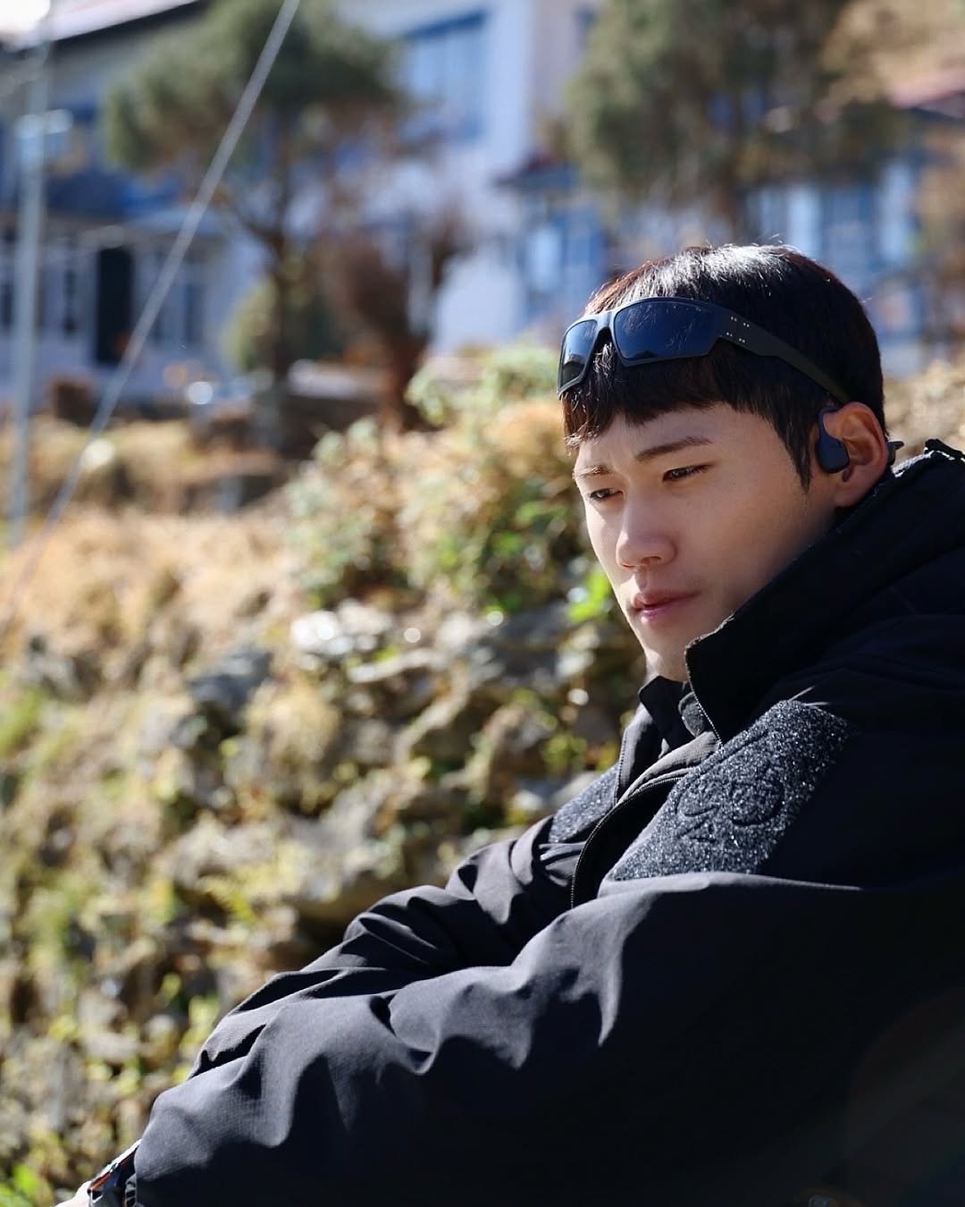 Photo shared by 이동규 on December 26, 2025 tagging @shokzkr. May be an image of duffle coat, hat, parka, face mask, outdoors and text.