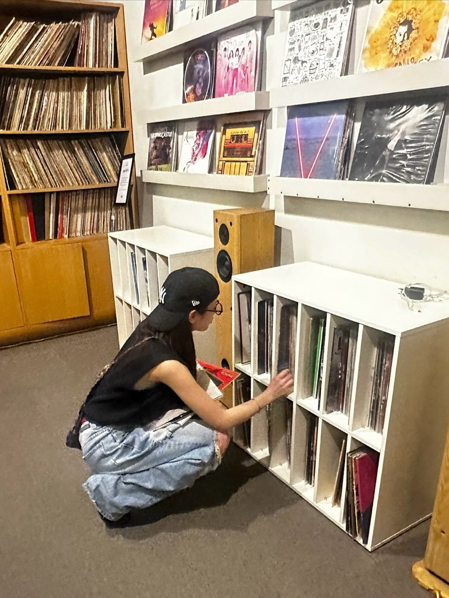 Photo by 장규리 on August 13, 2025. May be an image of 1 person, record player, rack, record, shelf, stereo and text.